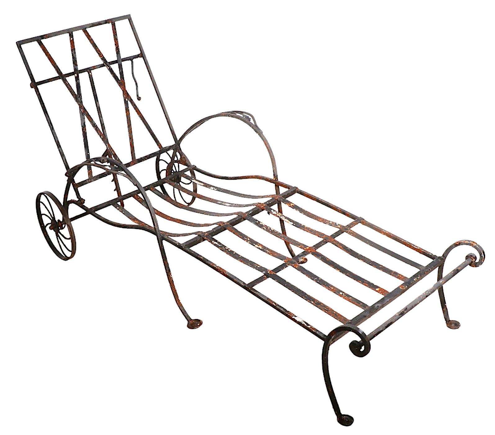 Adjustable wrought iron chaise lounge, made by John Salterini, as part of the Mt. Vernon series circa 1940's. This example displays the skills of the master of this genre, in both design and craftsmanship. The chaise has a reclining back, and rear