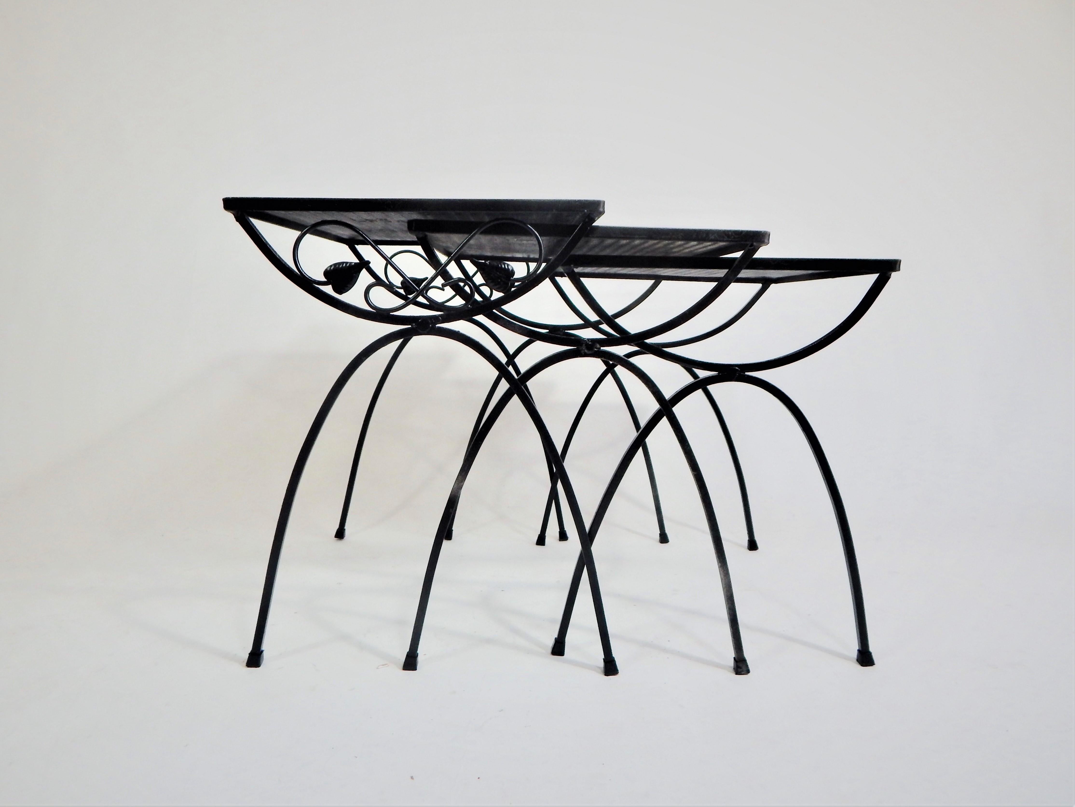 Midcentury set of three Salterini wrought iron nesting or stacking tables. Graduating sizes. Indoor Outdoor Patio Garden.  
Excellent condition.
Dimensions in inches:
Large table H 19.75, W 20.5, D 16
Medium table H 19, W 18.25, D 15.25
Small table