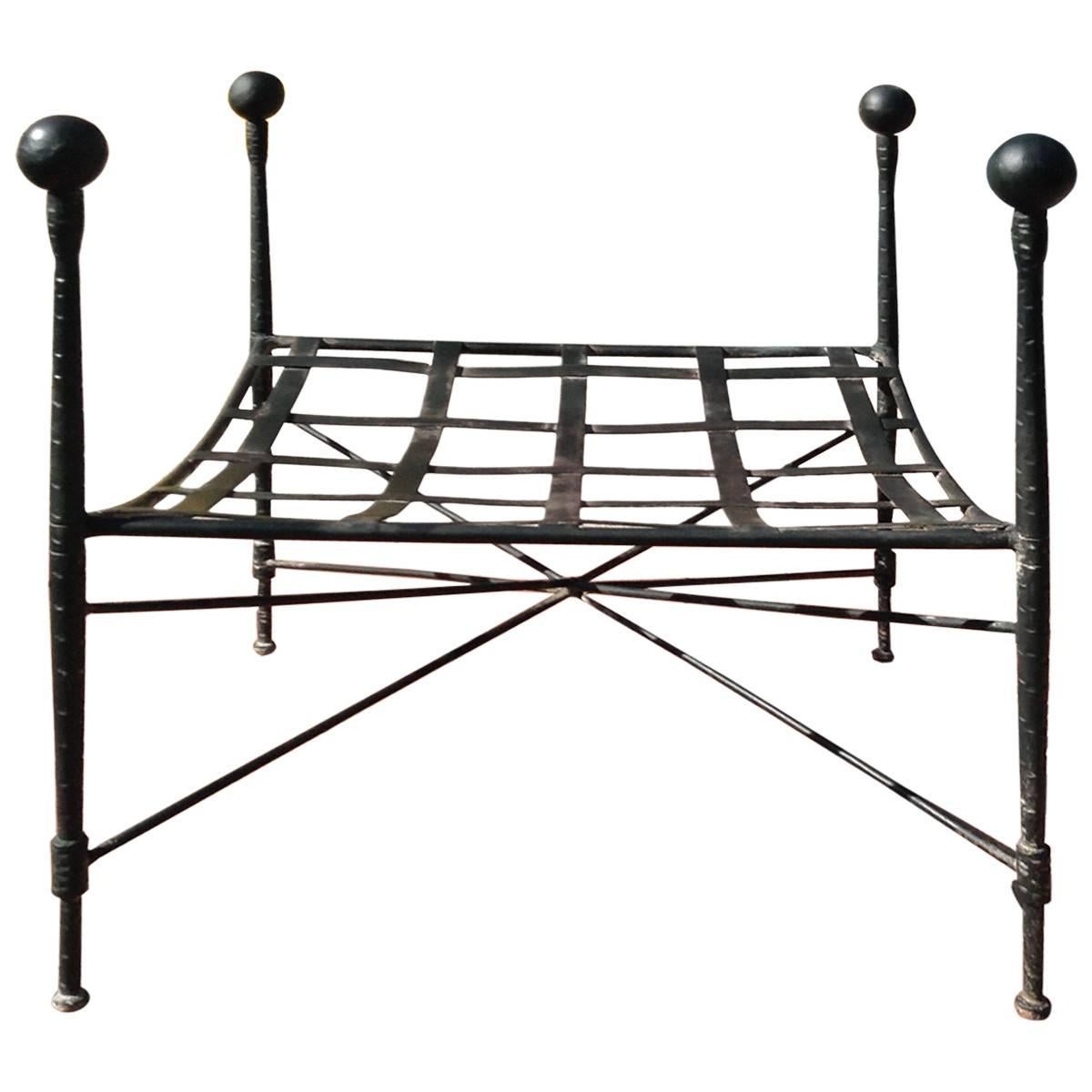 Salterini antiques specializes wirework and wrought iron furniture made in Salterini, simple but sleek, this eye-catching openwork ottoman is composed of patinated wrought iron and features a rich black finish and decorative ball finials. Designed
