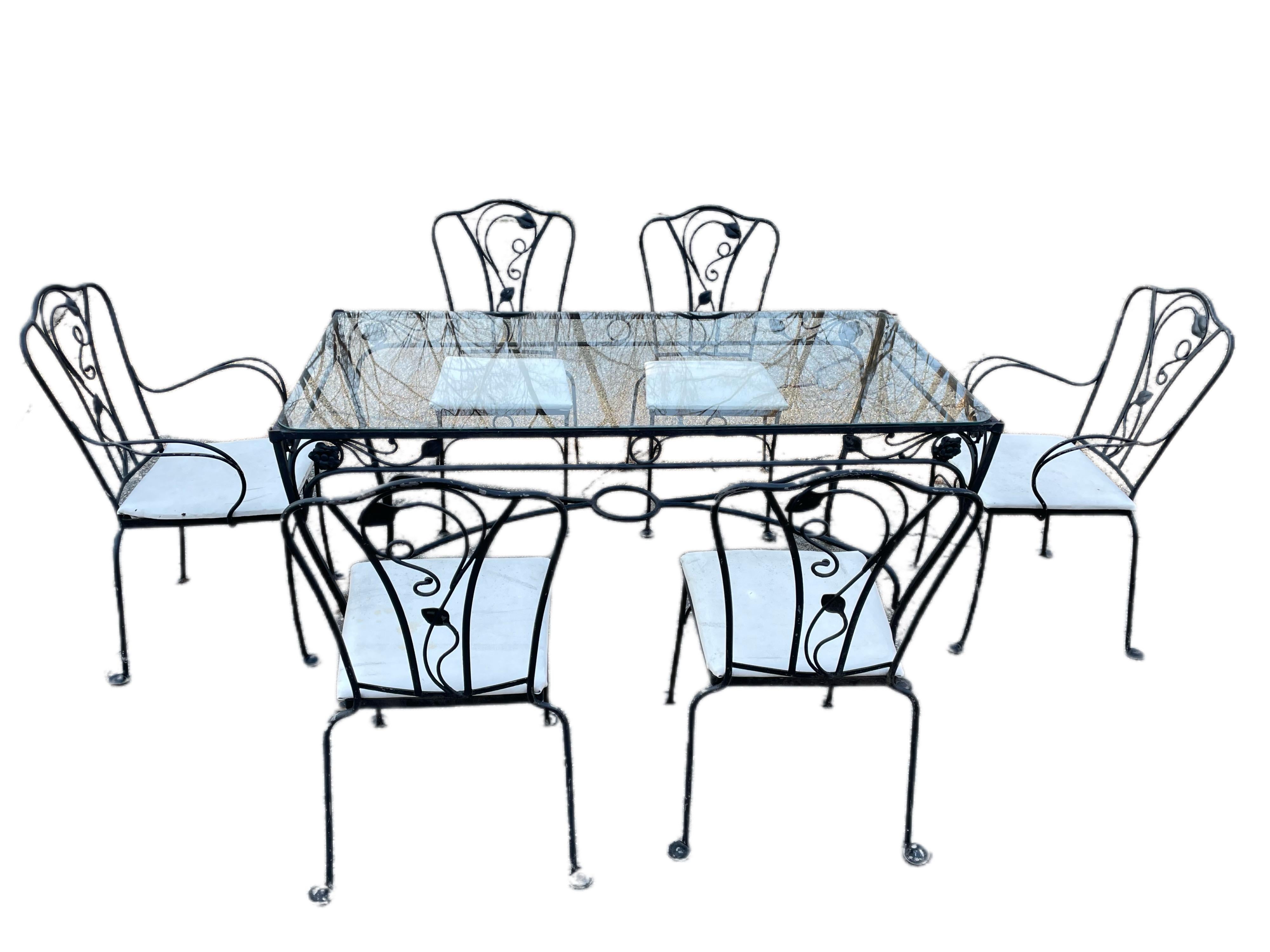 Salterini Dining Seating 7 Piece Set

Hard to find 60 inch table designed by Salterini. Seating for 6 people. Signature Salterini outward facing feet and floral motif. Enjoy this vintage wrought iron 7 piece dining set on your terrace, garden, or