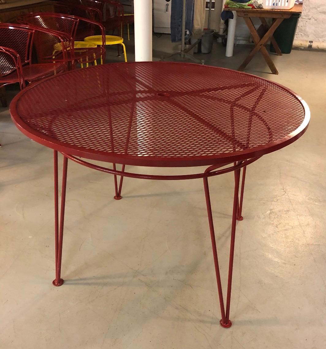 Stunning Salterini red patio dining table. John Salterini is widely credited as the cause of the resurgence in wrought iron garden furniture and his designs resembled the popular styles of this period, including Gothic Revival, Art Deco and
