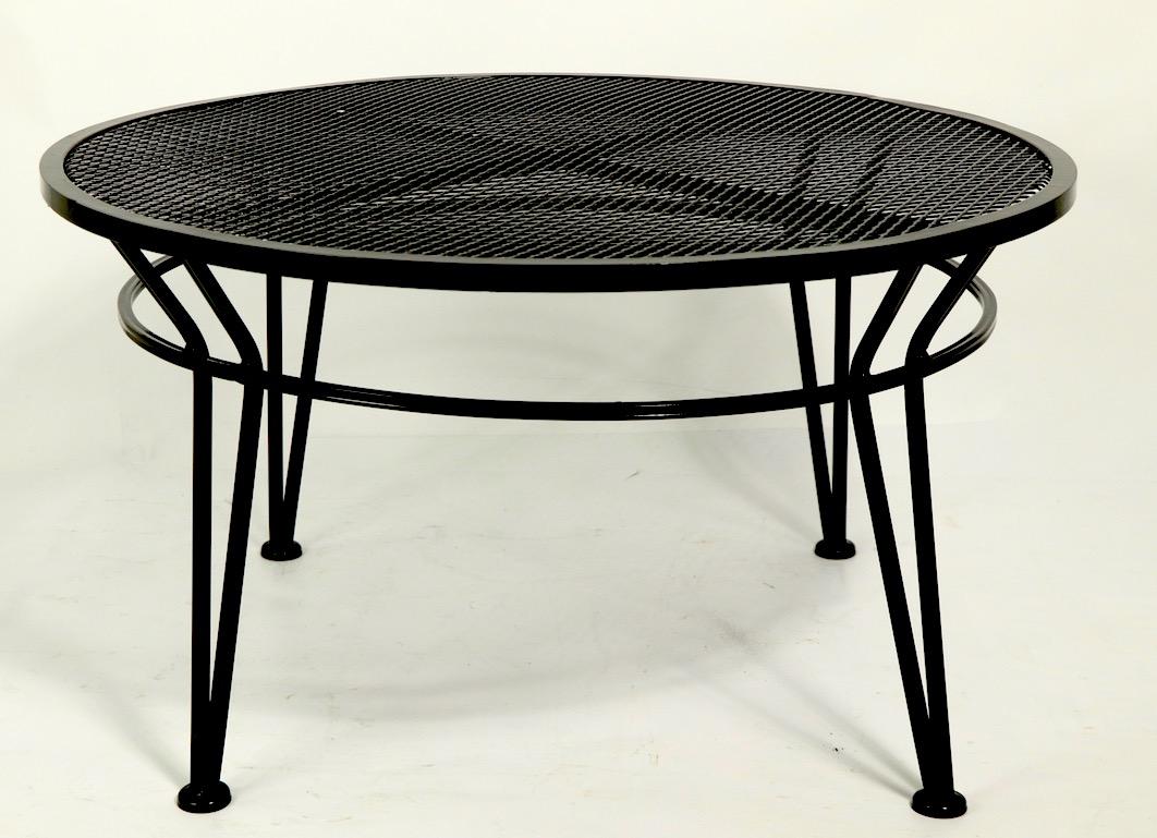 Slick and sophisticated Radar coffee, cocktail table by Salterini in new semi gloss black powder coat finish. Circular metal mesh top supported by wrought iron legs. Clean, ready to use, suitable for indoor and outdoor use.