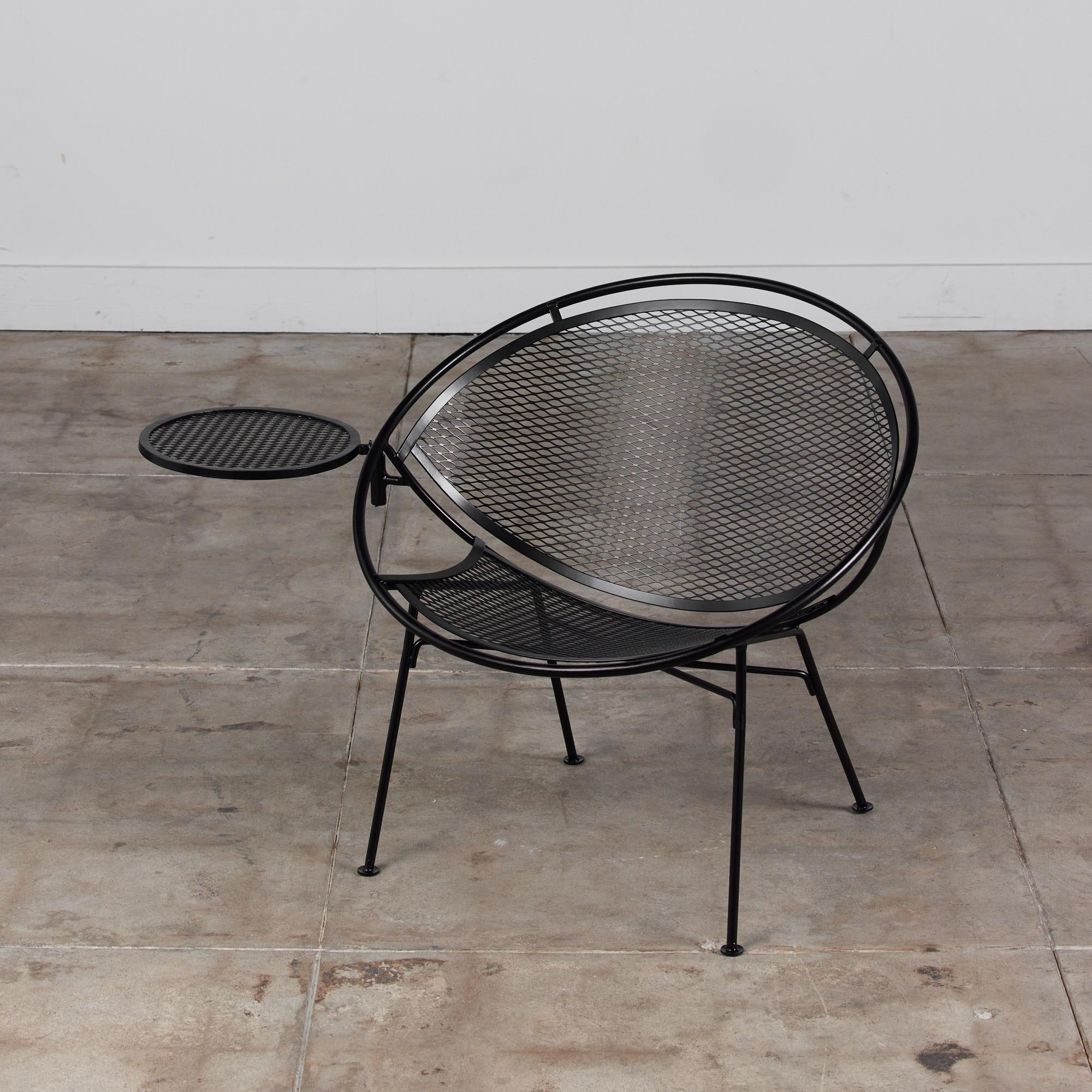 “Radar” wrought iron patio lounge chair designed by Maurizio Tempestini for John Salterini, c.1950s, USA. The chair has a bisected hoop construction with a delicate grid of wrought iron forming the body and a rare detachable drink table. Four angled