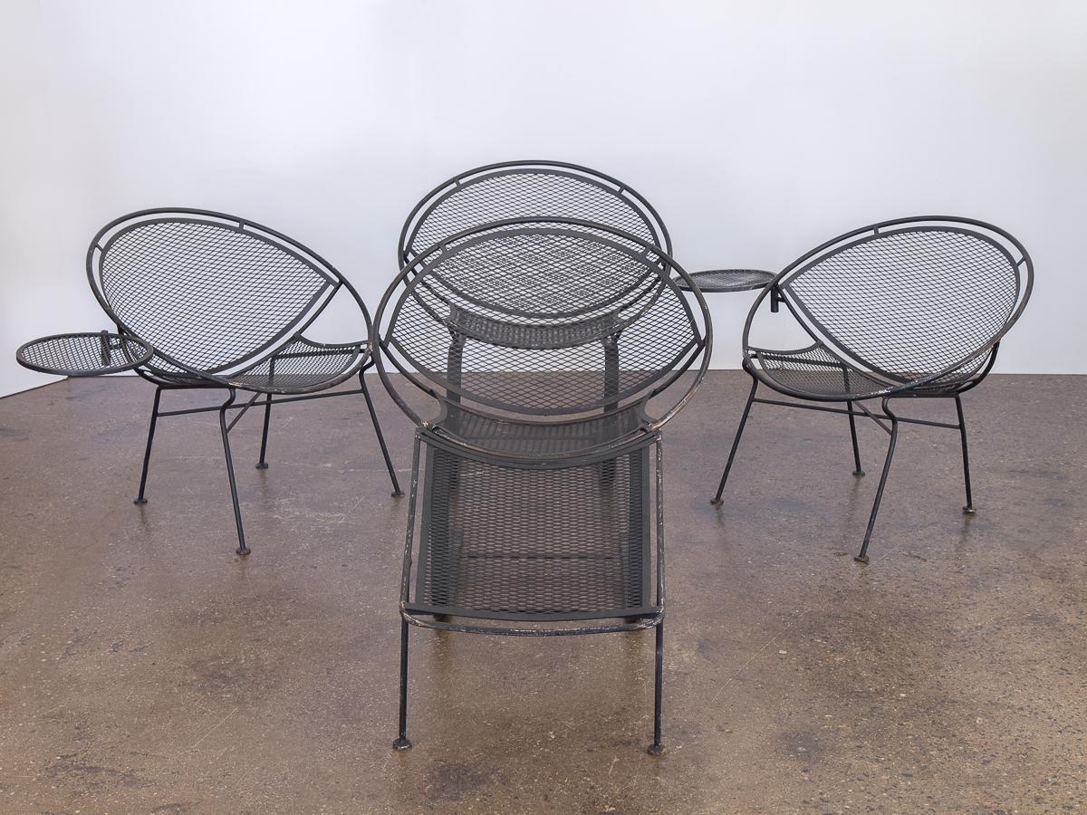 Georgeous set of wrought iron patio chairs designed by Maurizio Tempestini for Salterini. The set includes two chairs with a standard base in addition to two spring lounge chairs. The standard variations include detachable tables. The