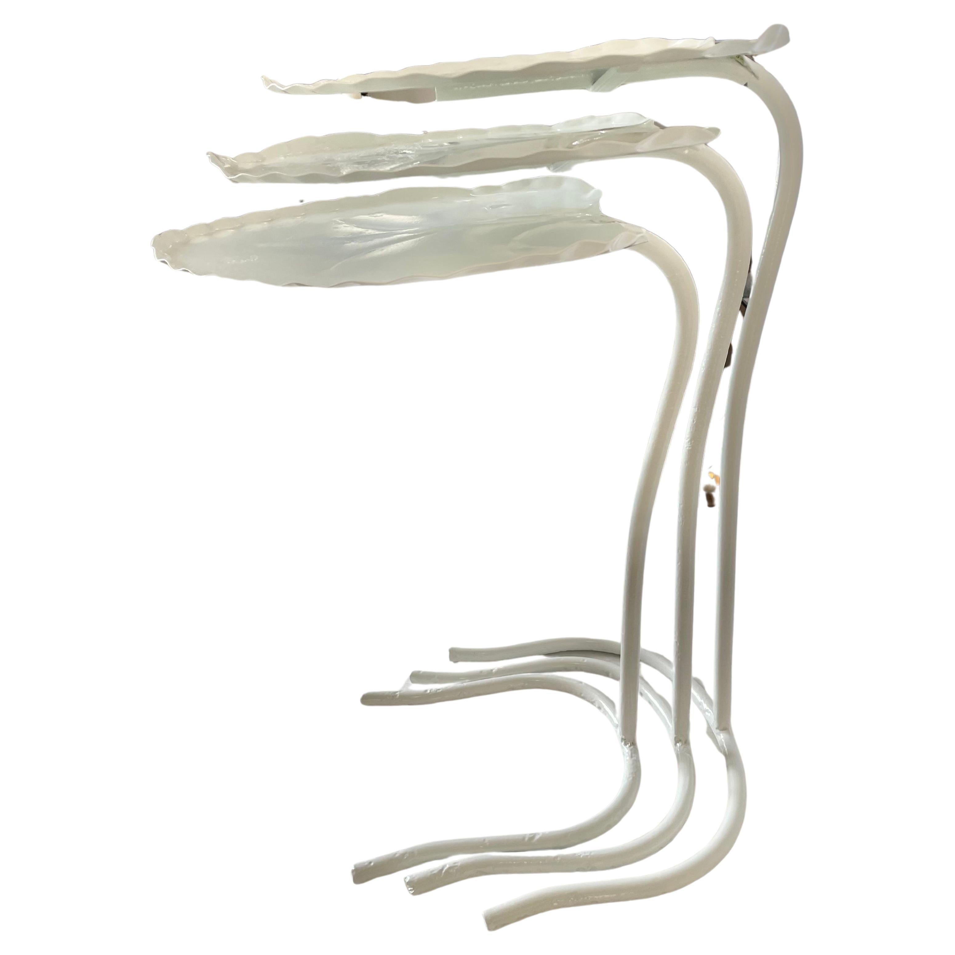 This stylish, chic and classic Salterini set of three lilly pad nesting tables have been professionally restored. The pieces have been sandblasted and powdercoated in Palm Beach White. 

Note: Height of tallest table is 22.50