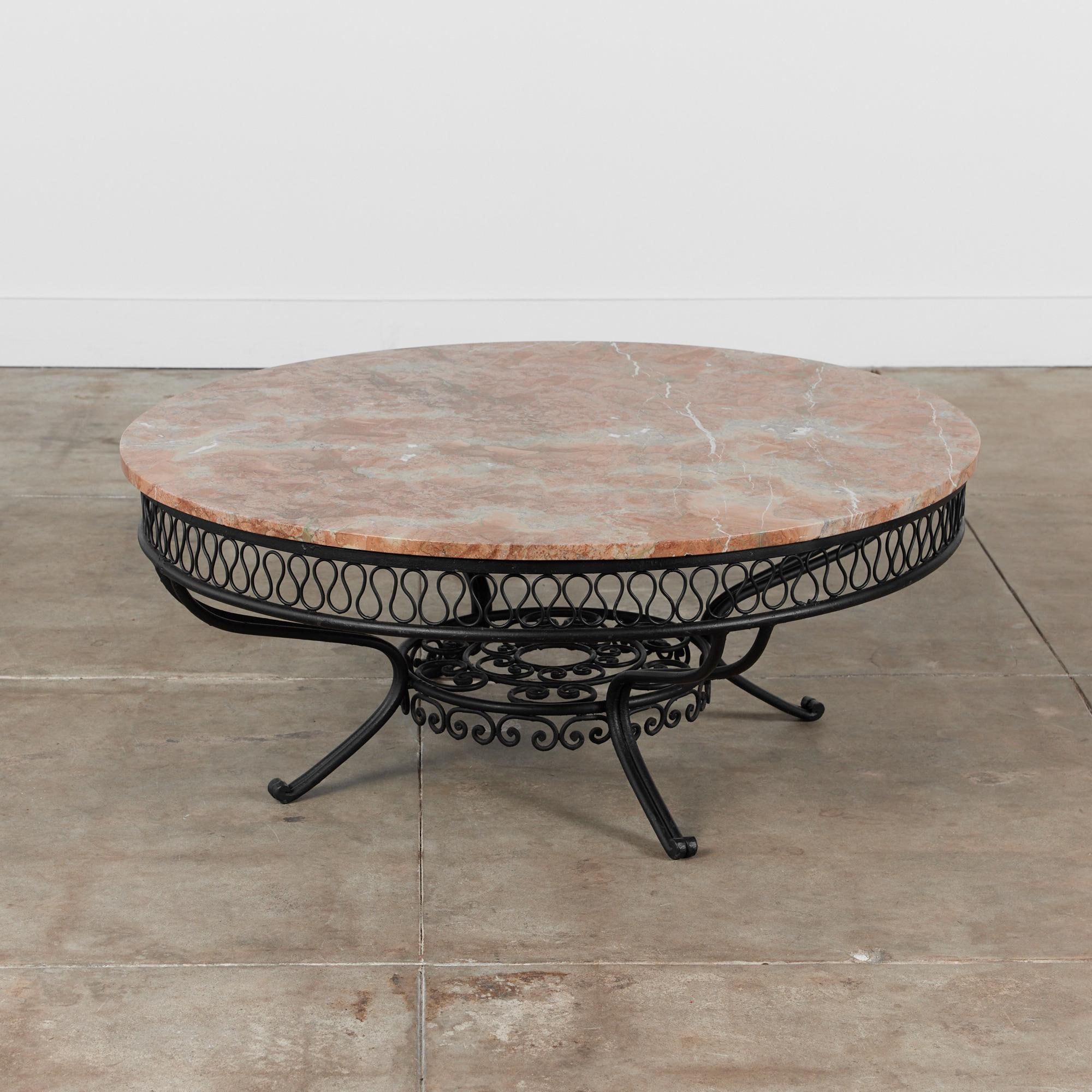 Coffee table in the style of Maurizio Tempestini for John Salterini, USA, circa 1950s. This round table features Tempestini's ribbon style detailing under the base of the table top. The table has been newly powdered coated in a black satin finish