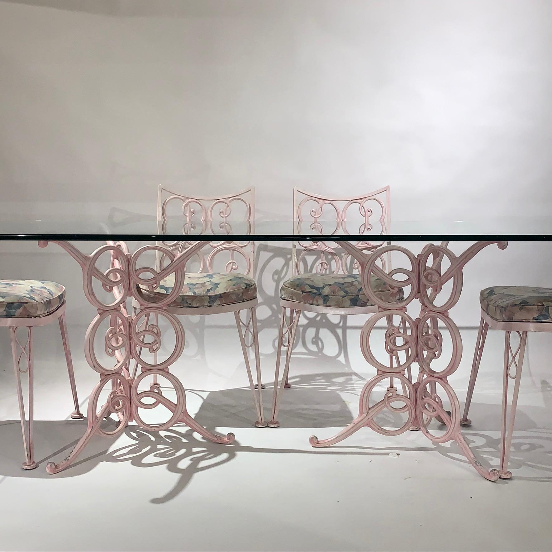 Fabulous Curlicue wrought and cast metal garden patio set -Pink with heavy thick glass table that includes 6 upholstered chairs and a thick heavy glass tabletop that sits atop two decorative cast metal bases.
Each base piece could be used as a