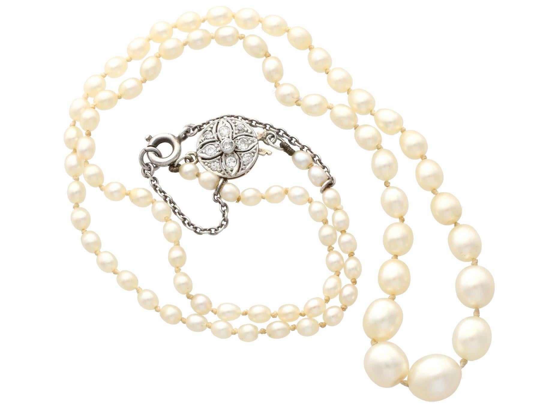 A fine and impressive single strand, saltwater natural pearl necklace with a 0.15 carat diamond, 15 karat yellow gold and platinum set clasp; part of our diverse necklace and pendant collection.

This fine and impressive single strand pearl necklace