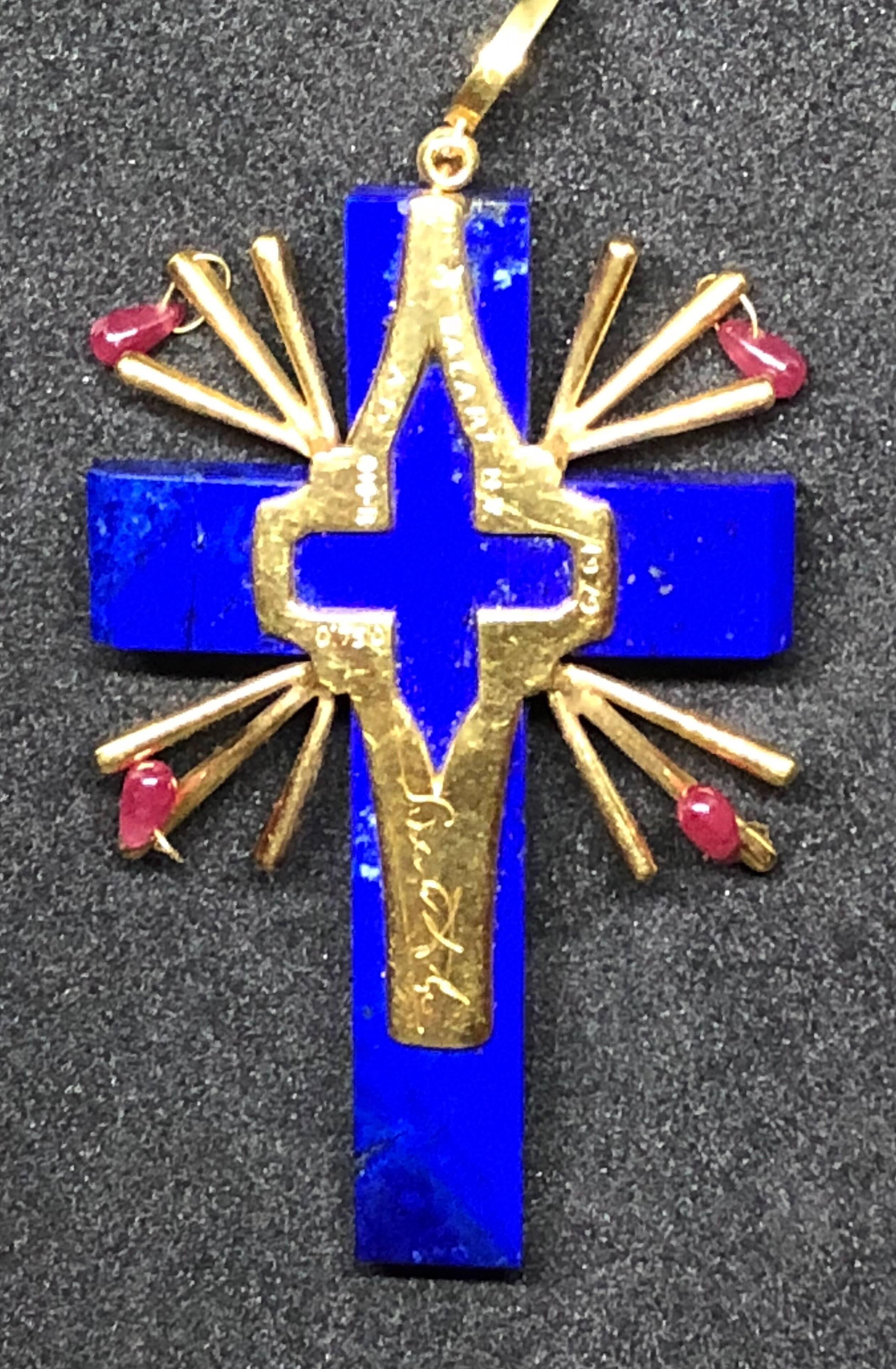 Salvador Dali (1904-1989) crucifixion- necklace Limited edition lapis lazuli sculpture, gold with small diamonds with approx. 0.29-carat and pear cut rubies pendant. 16 gold and diamonds aplpliqués.
Original 18-carat gold necklace
This is the