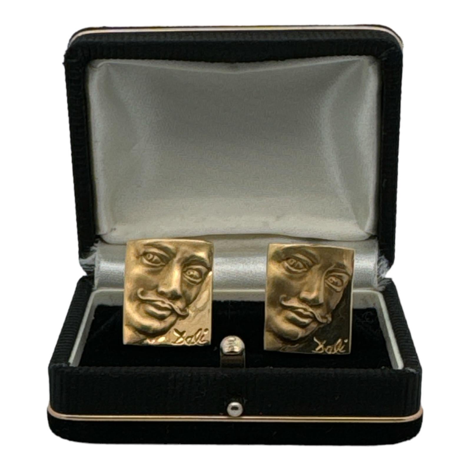 Salvador Dali Museum portrait cufflinks crafted in polished and satin finish 18 karat yellow gold. The cufflinks measure 18 x 22mm and weigh 27.4 grams.