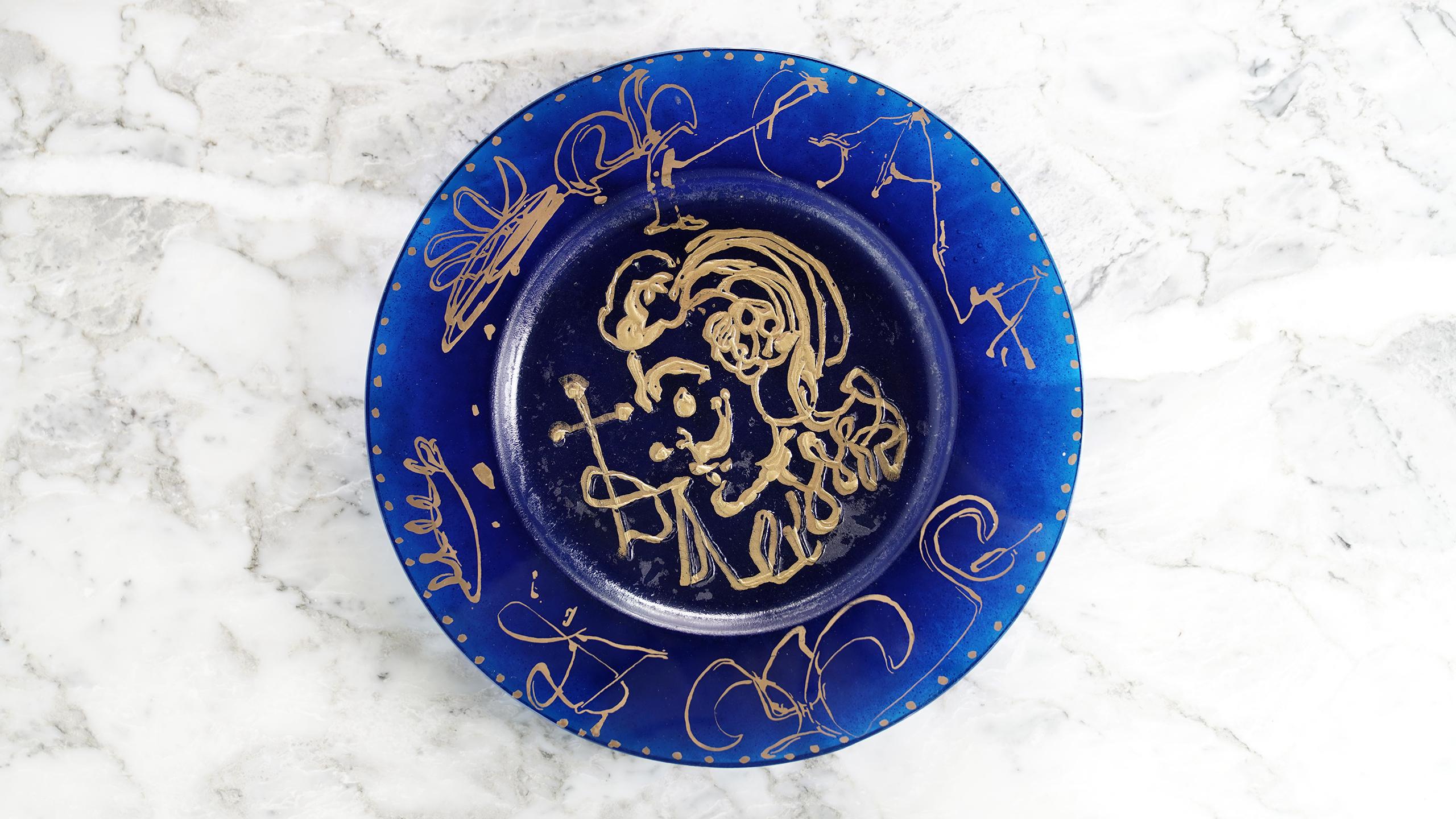 In the 1970s Daum, the French art glass company, invited Salvador Dali to design a limited edition of pa^te de verre plates. 
Dali's title 