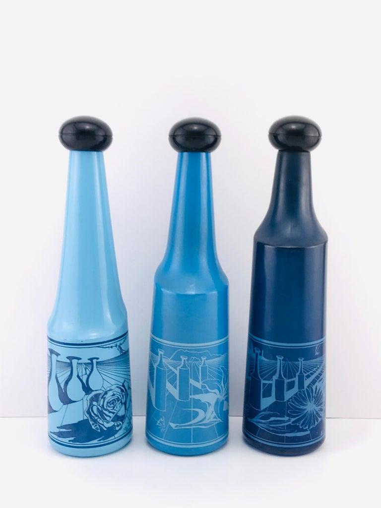 Excellent vintage condition original stoppers in tact
Beautiful succession of blue color light to dark
Each has a different serigraphed image created by Salvador Dali
Surrealist views of vineyards focusing on flower motif for each bottle with Dali's