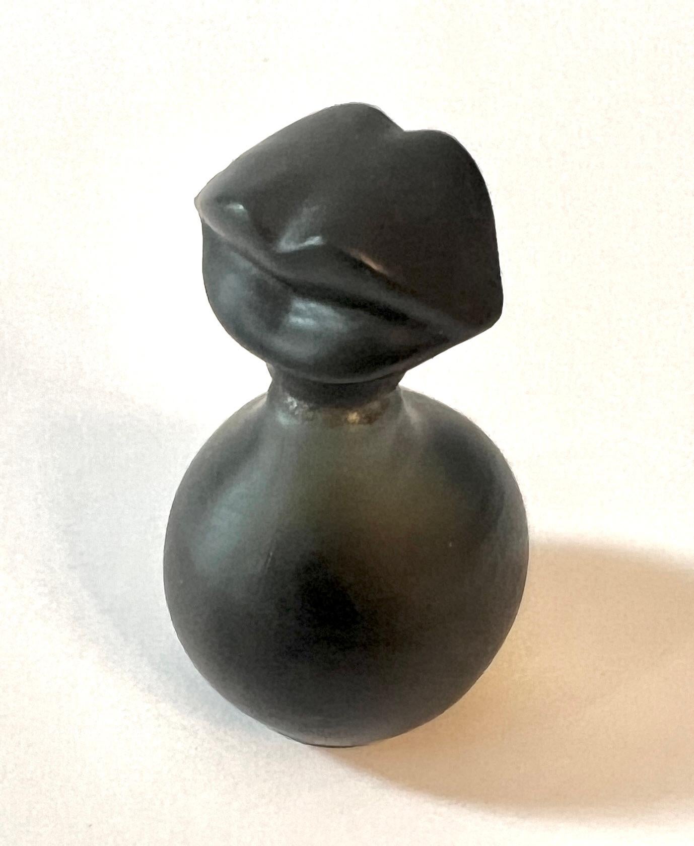 Salvador Dali, one of the world's most important artists, designed this beautiful small perfume bottle.  Currently there is perfume in it, could be from his original.

Dali's art often repeated objects from other themes.  The lips he borrowed from