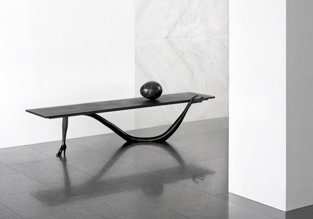 Leda low table designed by Dali manufactured by BD.

Legs in black patina not varnished.
tabletop in brushed and varnished brass, black varnished patina.
Nero Marquina marble egg on top.

Measures: 51 x 190 x 61 H.cm

Year: 2009

The black