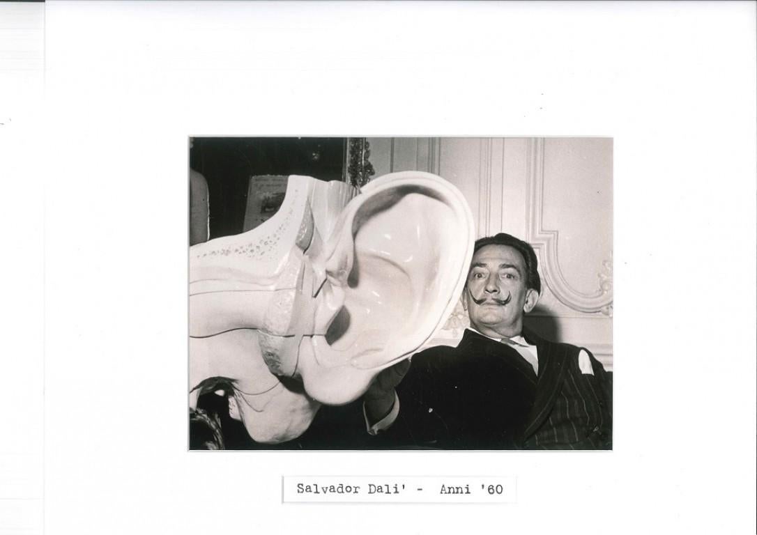 Salvador Dalí Portrait Photograph - The Famous Surrealist Painter and the Replica of the Ear - Photo - Surrealist