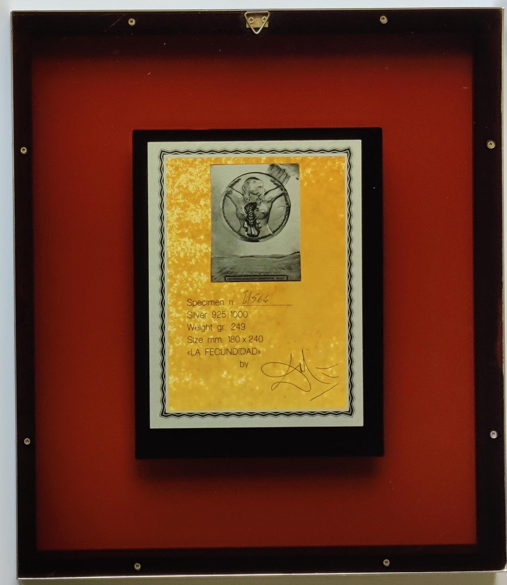 Salvador Dali 
Fecundity - Bas Relief Silver Sculpture, 1977
Dimensions: 24 x 18 cm
Framed: 38 x 33 cm
Signed on the bas relief and printed signature on the certificate on the back.
Edition number: I/564
This limited edition plaque was mounted to