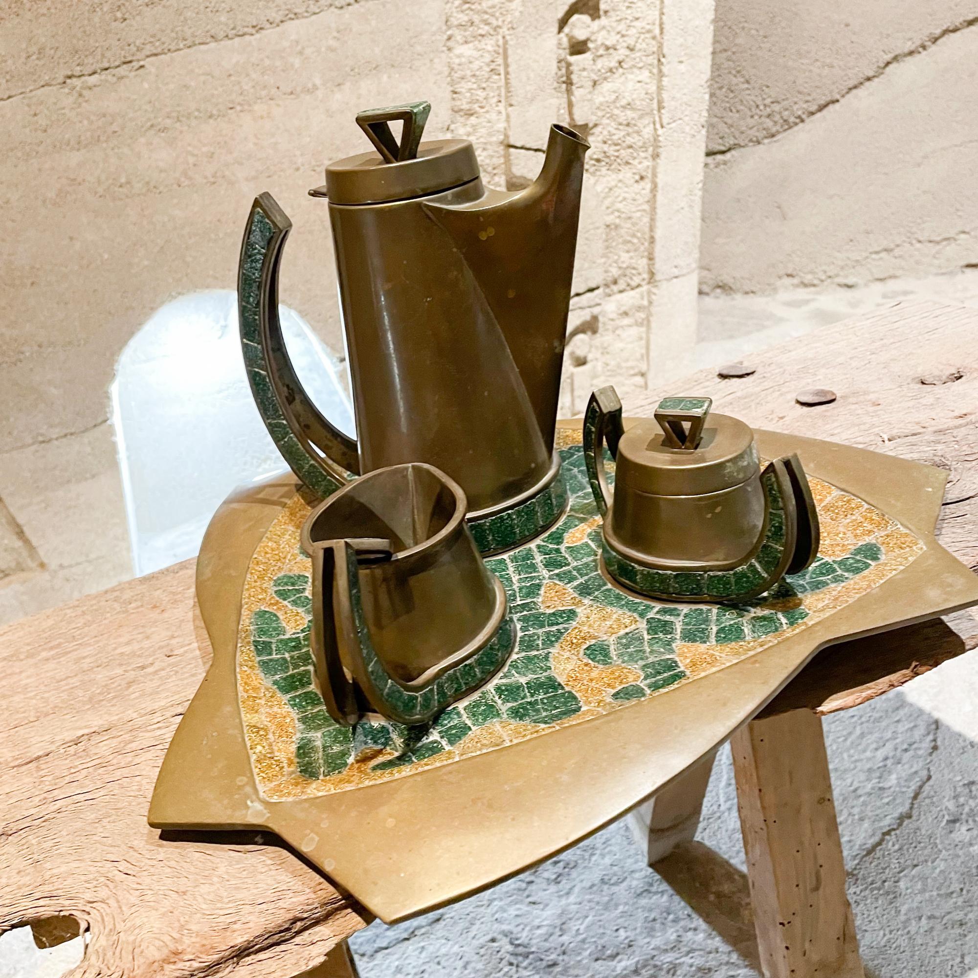 AMBIANIC presents:
Fabulous handwrought Made in Mexico by Salvador Teran Coffee Tea Set- Spoon & Serving Tray.
Five piece Set. Tray included.
Handcrafted in patinated Brass with exquisite Turquoise Stone Tile Mosaic.
Set Includes: 
1.Coffee Pot: