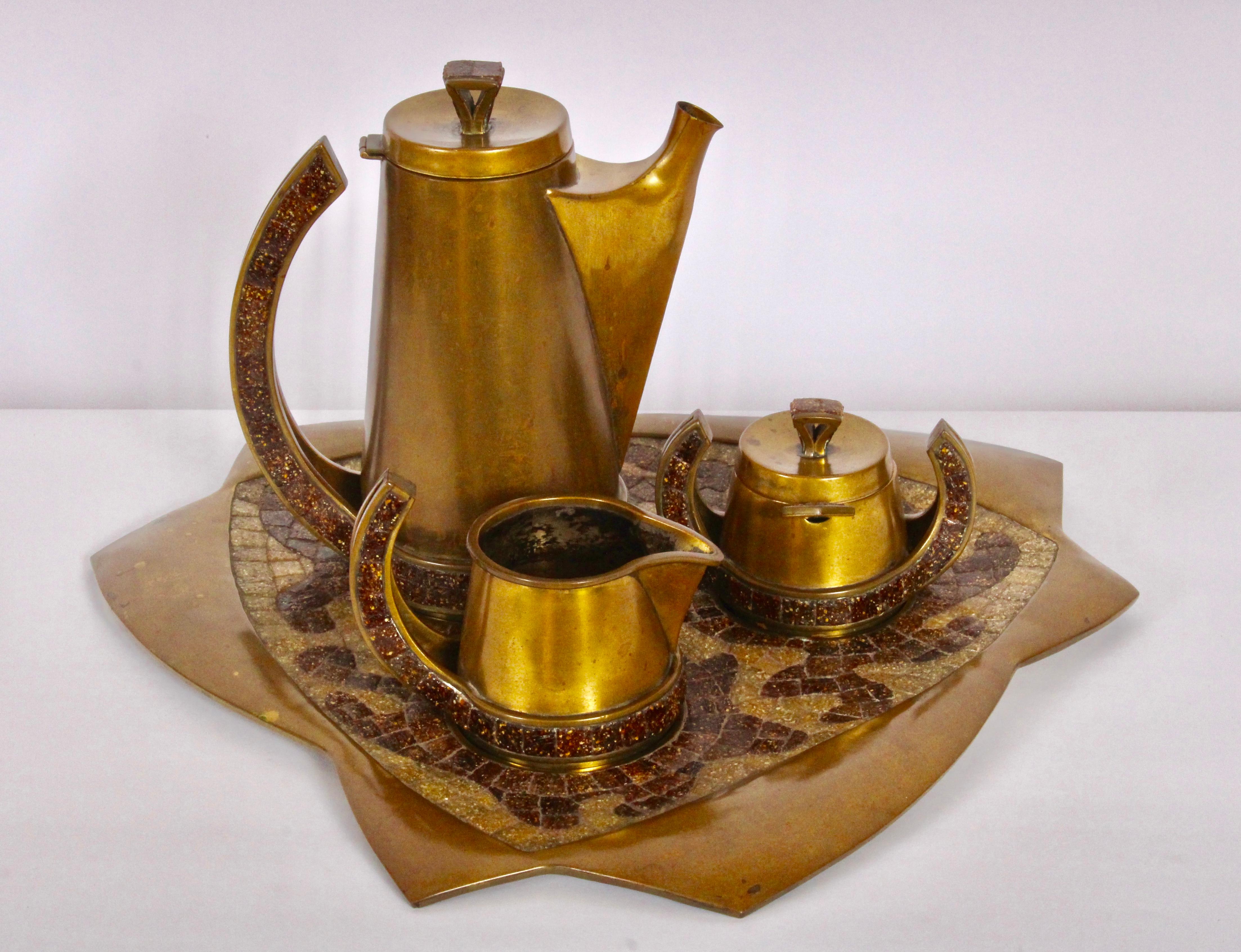 Mid-Century Mexican Modern solid brass and glass tile Mosaic coffee service by Salvador Teran. Reflective Copper toned 7-piece set. Featuring tile embellished Brass tea pot / coffee server, lid, sugar bowl with spoon and lid, creamer and serving