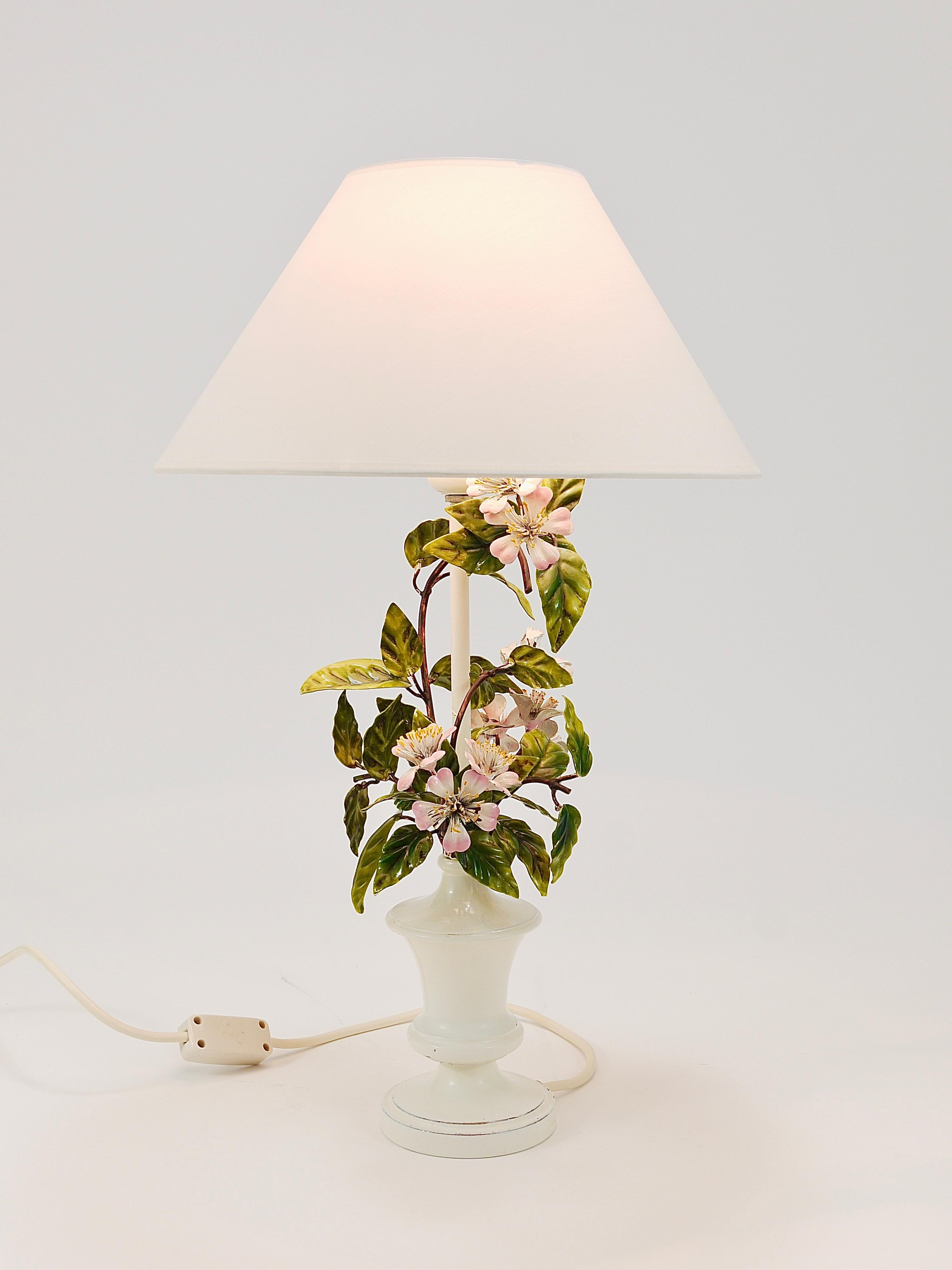 A charming vintage floral side or table lamp from the 1950s, handmade of metal by S. Salvadori, Italy. A lovely colorful Mid-century light with hand-painted wild apple blossoms and leaves. In good condition with age-related patina. Labelled on its