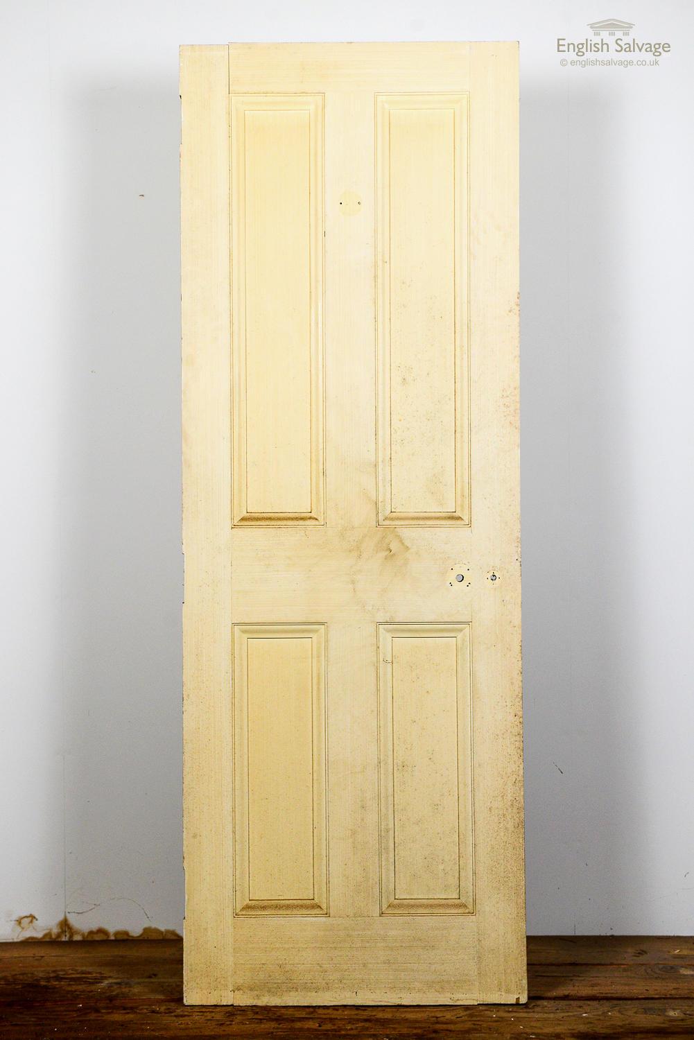 Salvaged painted pine four panelled interior door, which is part of a set of matching doors. Chips and scratches to the surface and paint commensurate with age and use.