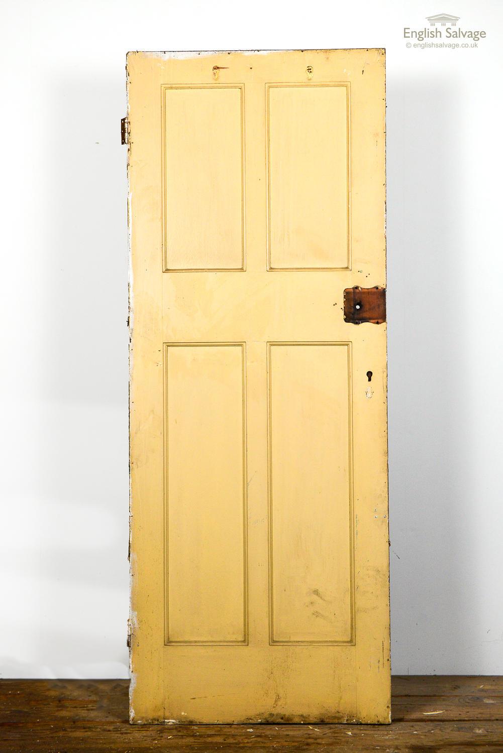 Salvaged Victorian style 4-panelled door in pine, currently painted. This is part of a set of matching doors - this one has been hung with the smaller panels above, and has previously had a facing panel fitted on one side.
