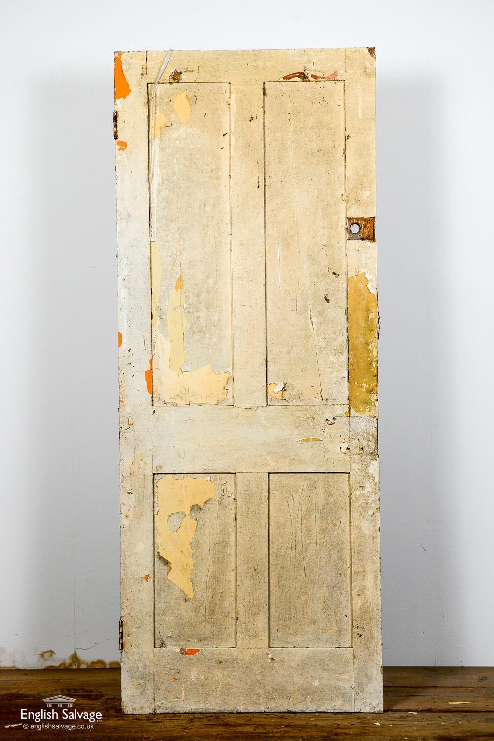 Salvaged 4-panel painted pine door with distressed paint finish. Hole from previous lock fitting.