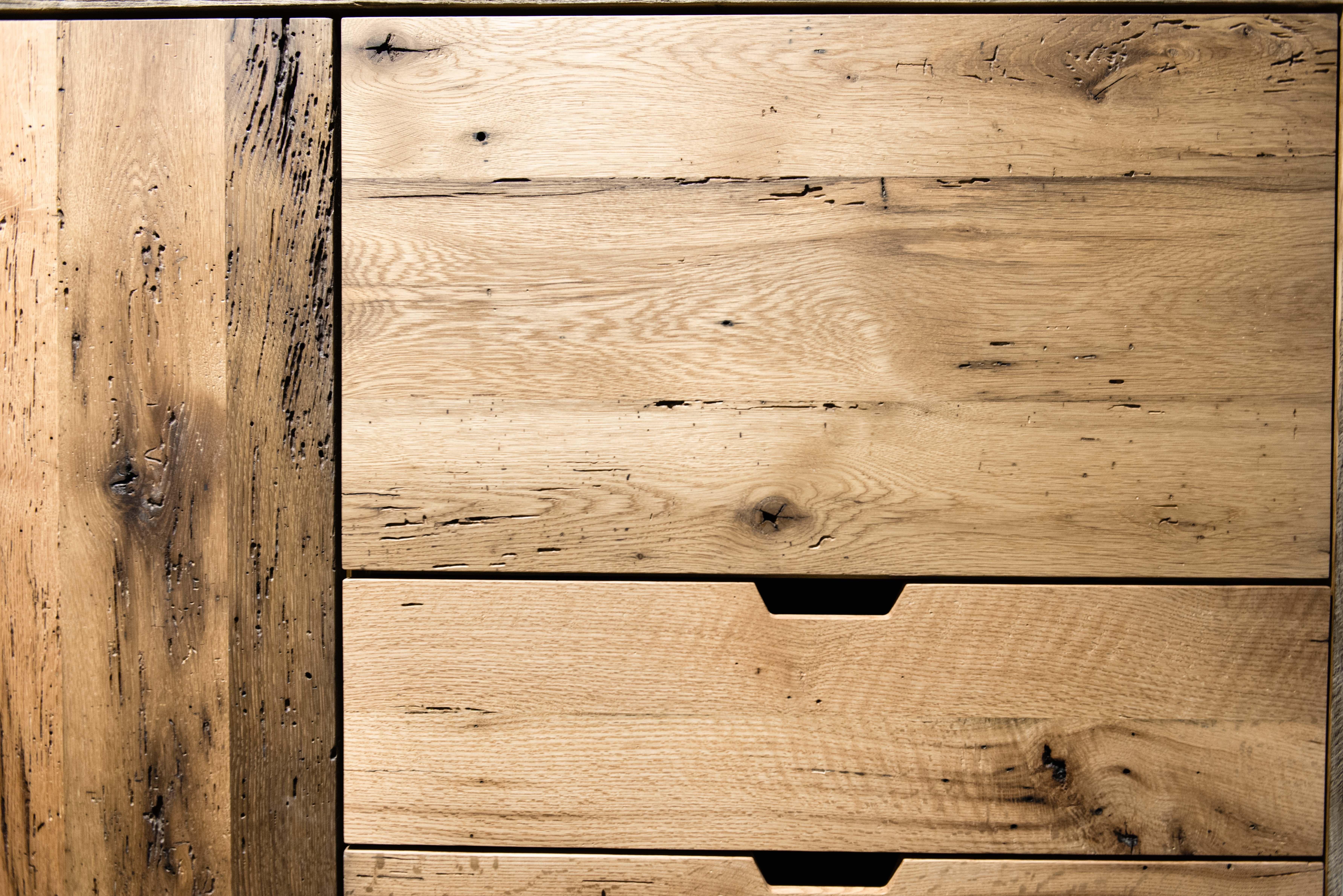Handcrafted in reclaimed white oak and pine. All wood was repurposed from a barn in Hampden MA that was built in 1780. The doors and drawers are constructed with solid oak that came from the floor boards. The wardrobe doors feature a subtle curve