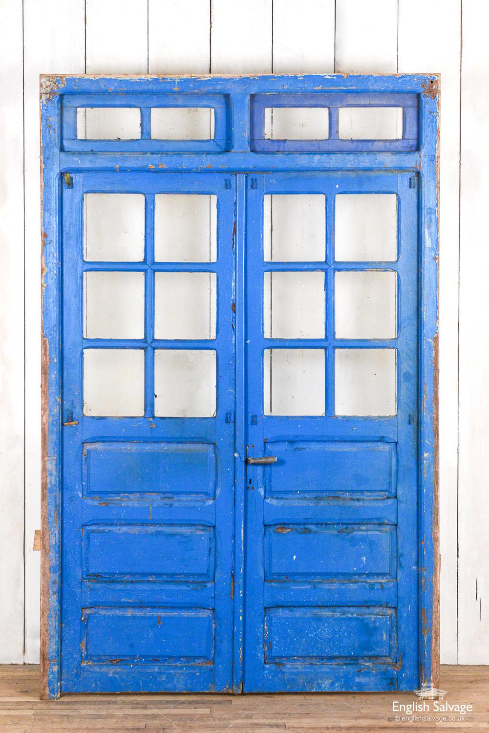 Striking set of glazed multi panel doors salvaged in Morocco. The paint is a vibrant blue colour with an appealing weathered and cracked surface patina. The door handle is Art Deco in style and the interior locking system is an espagnolette bar