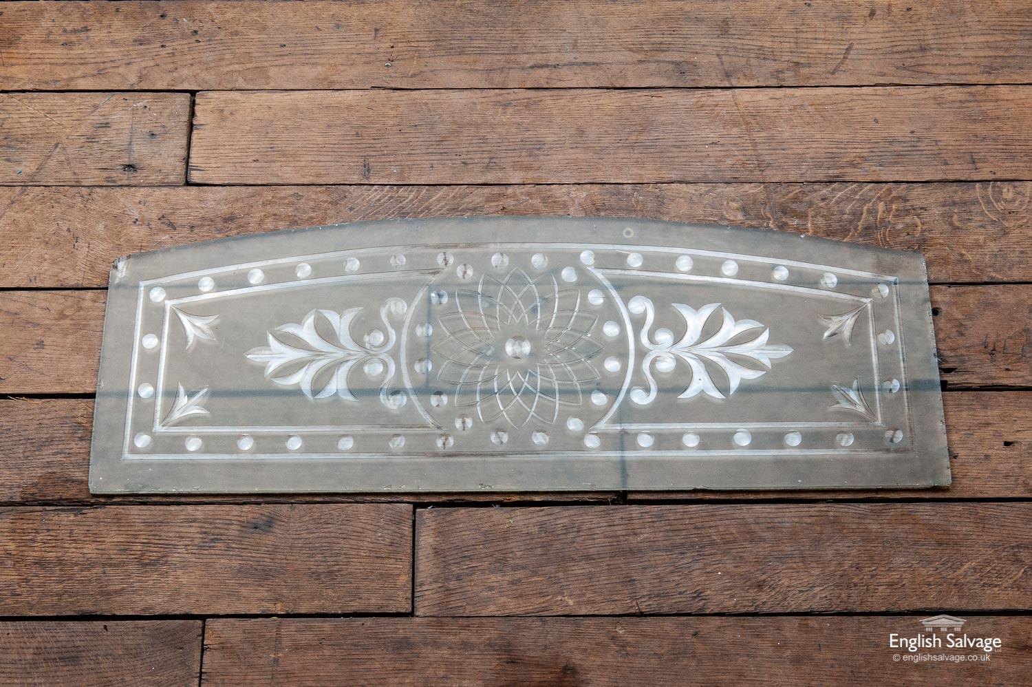 This reclaimed etched glass panel with an arched top has attractive leaf detailing and a circles design border with a geometric curved design at the centre. There are some chips and nibbles to the edges, but overall it appears to be in sound