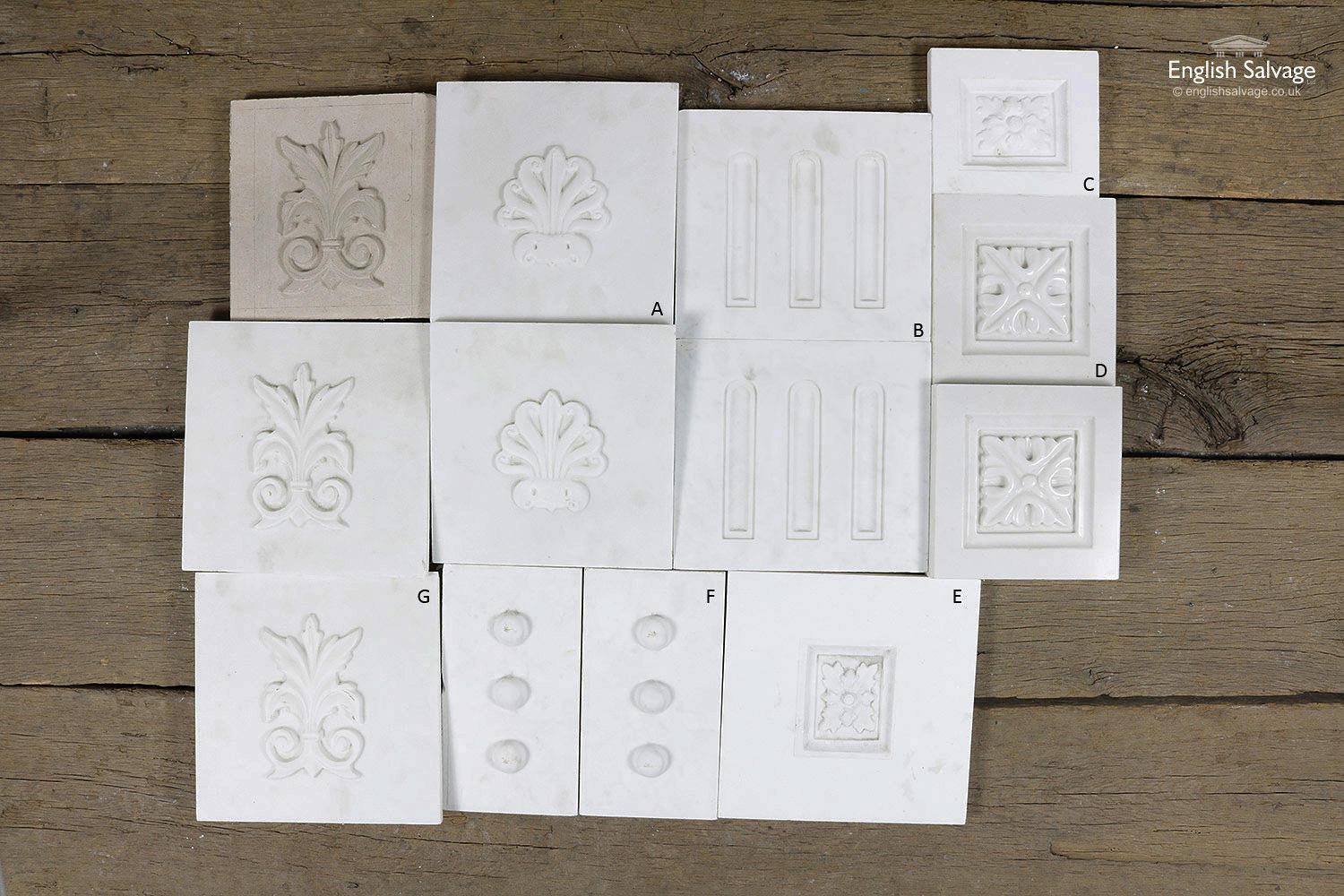 Salvaged marble plaques with carved motifs in several different designs.
