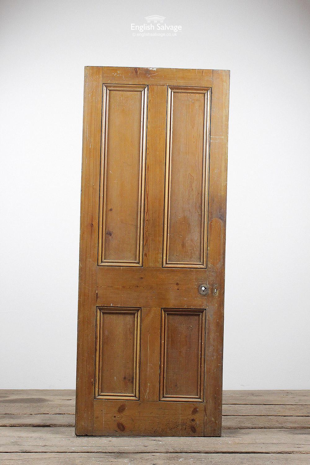 Old four panel pine door with beading to the both sides. Old fitting holes. Cut on the slant.