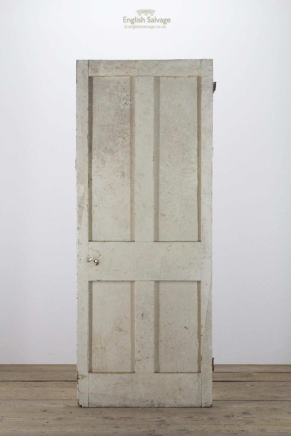 Salvaged pine four plain panel interior door. Lock, handle and nail holes present.