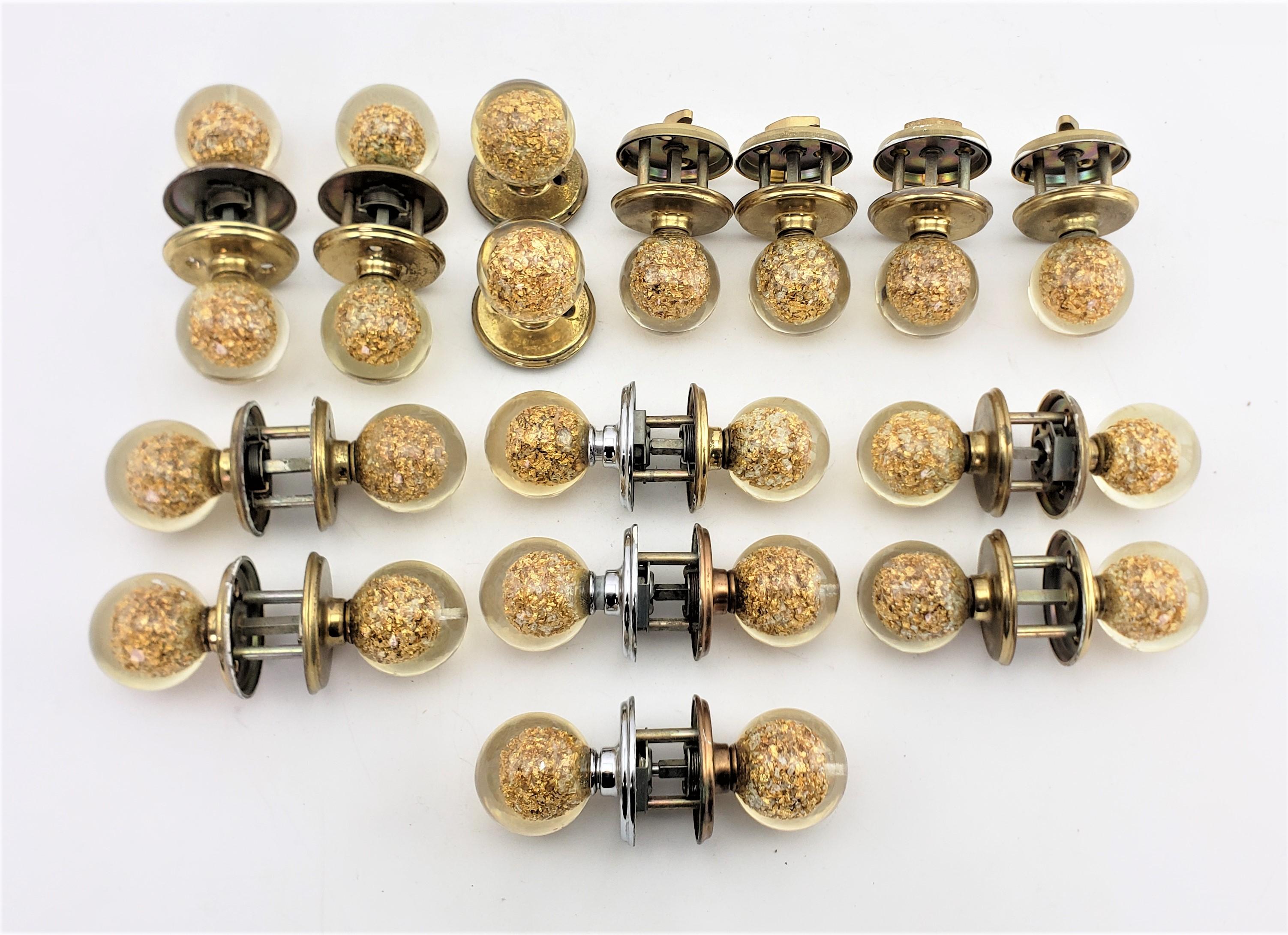 This set of door knobs and hardware were designed by Ruth Richmond for Weiser in approximately 1970 and done in the period Mid-Century Modern, or Hollywood Regency style. The knobs themselves are a signature style for Ruth Richmond and are composed