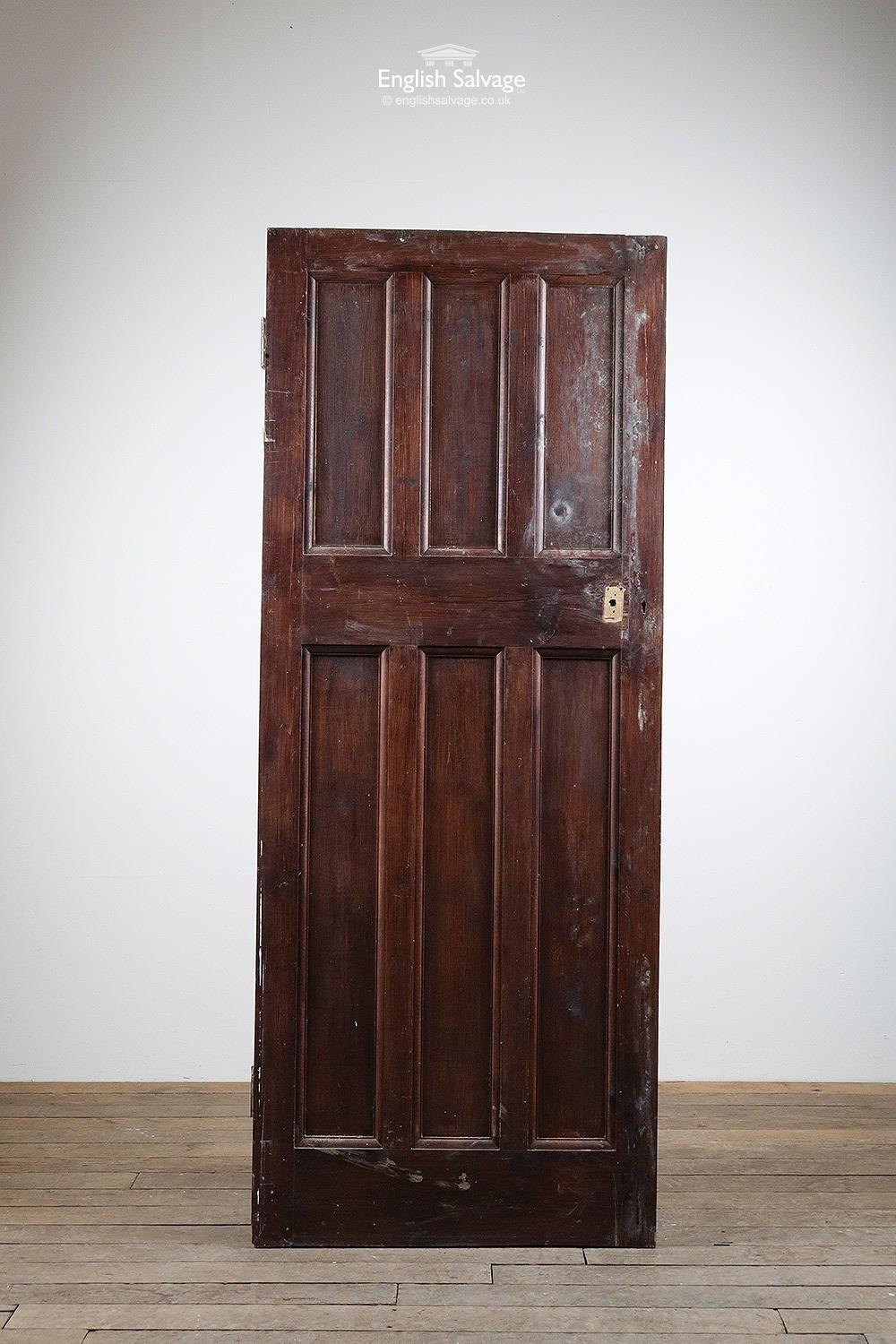 Reclaimed six panel / three over door stained a dark reddish brown. Old lock hole. Few scuffs and marks but a good solid door.