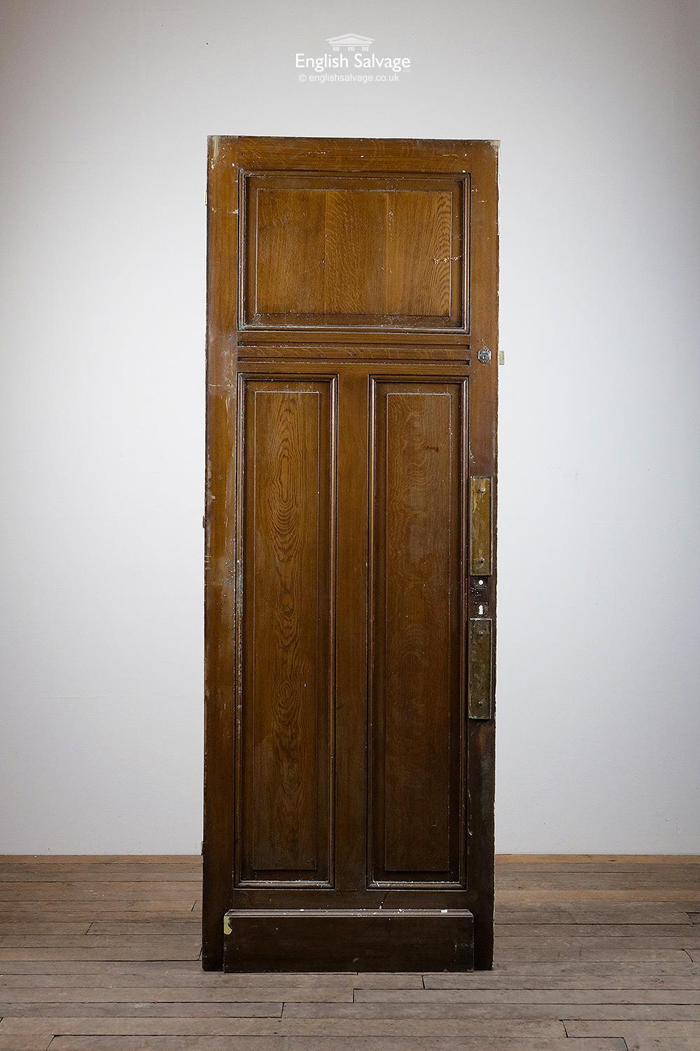 One of a set of tall pine one over two doors from France. Raised and fielded panels and base board both sides. Old hinges, fittings and holes. White paint is grubby and flaking to the one side, oak stain effect to the other with two brass push