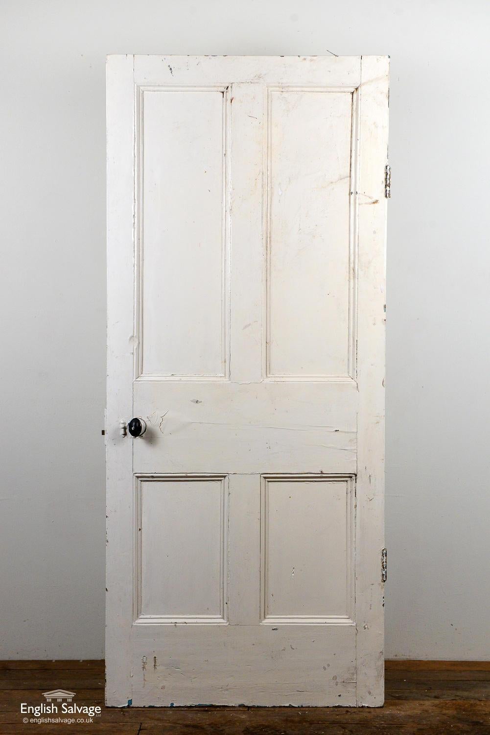 Victorian pine door with four beaded panels and two hinges. Some chips and dings to a few panels and edges.