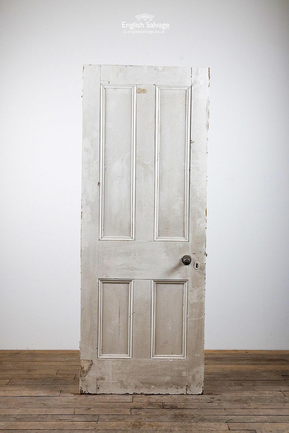 Salvaged four panel Victorian door with beading both sides. Working rim lock (no key) and Bakelite handle. Two hinges, splits to panels. Chips to the paintwork.