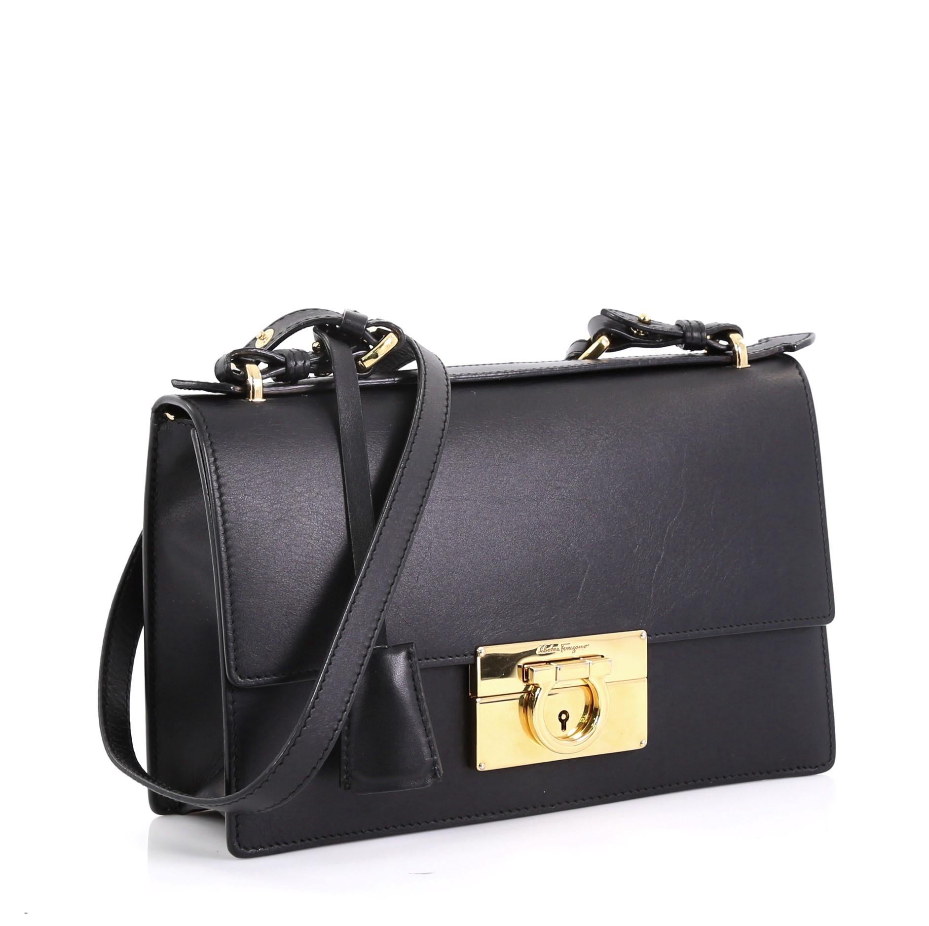 This Salvatore Ferragamo Aileen Shoulder Bag Leather Medium, crafted from black leather, features an adjustable shoulder strap and gold-tone hardware. Its clasp closure opens to a black leather interior with zip pocket. 

Estimated Retail Price: