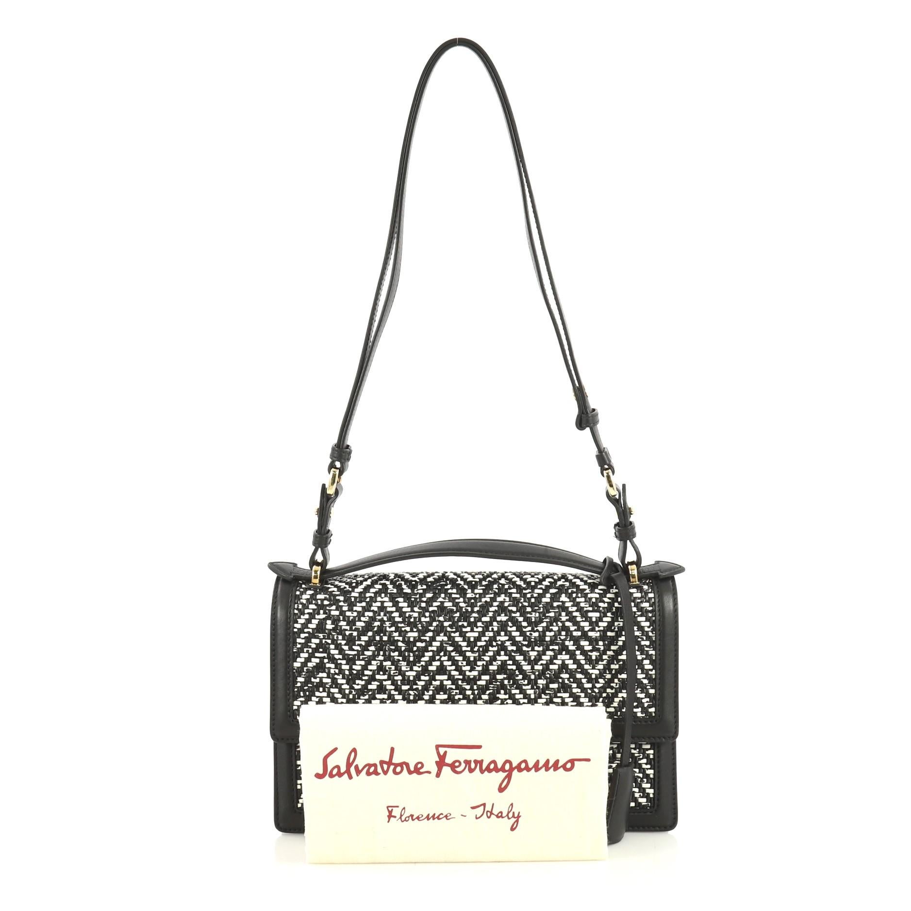 This Salvatore Ferragamo Aileen Shoulder Bag Woven Leather Medium, crafted from black woven leather, features an adjustable shoulder strap and gold-tone hardware. Its clasp closure opens to a black leather interior with zip pocket. 

Estimated