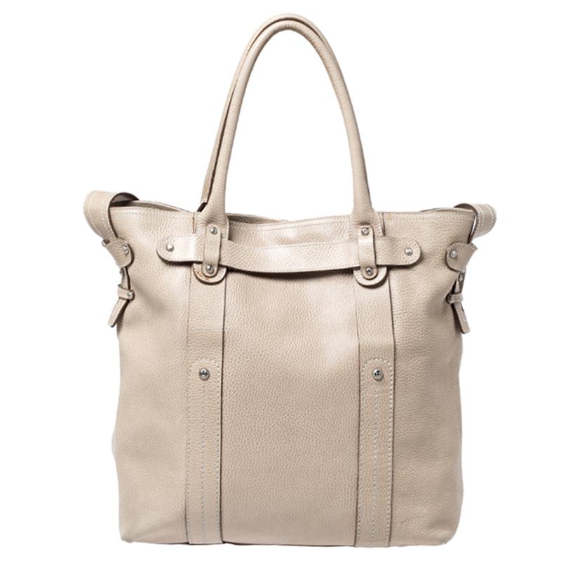 Durable and easy to carry, this beige leather bag is truly a must-have for your closet. Designed in a simple style, the tote is by Salvatore Ferragamo. It has a spacious fabric interior, two handles and a shoulder strap.

Includes: Original Dustbag,