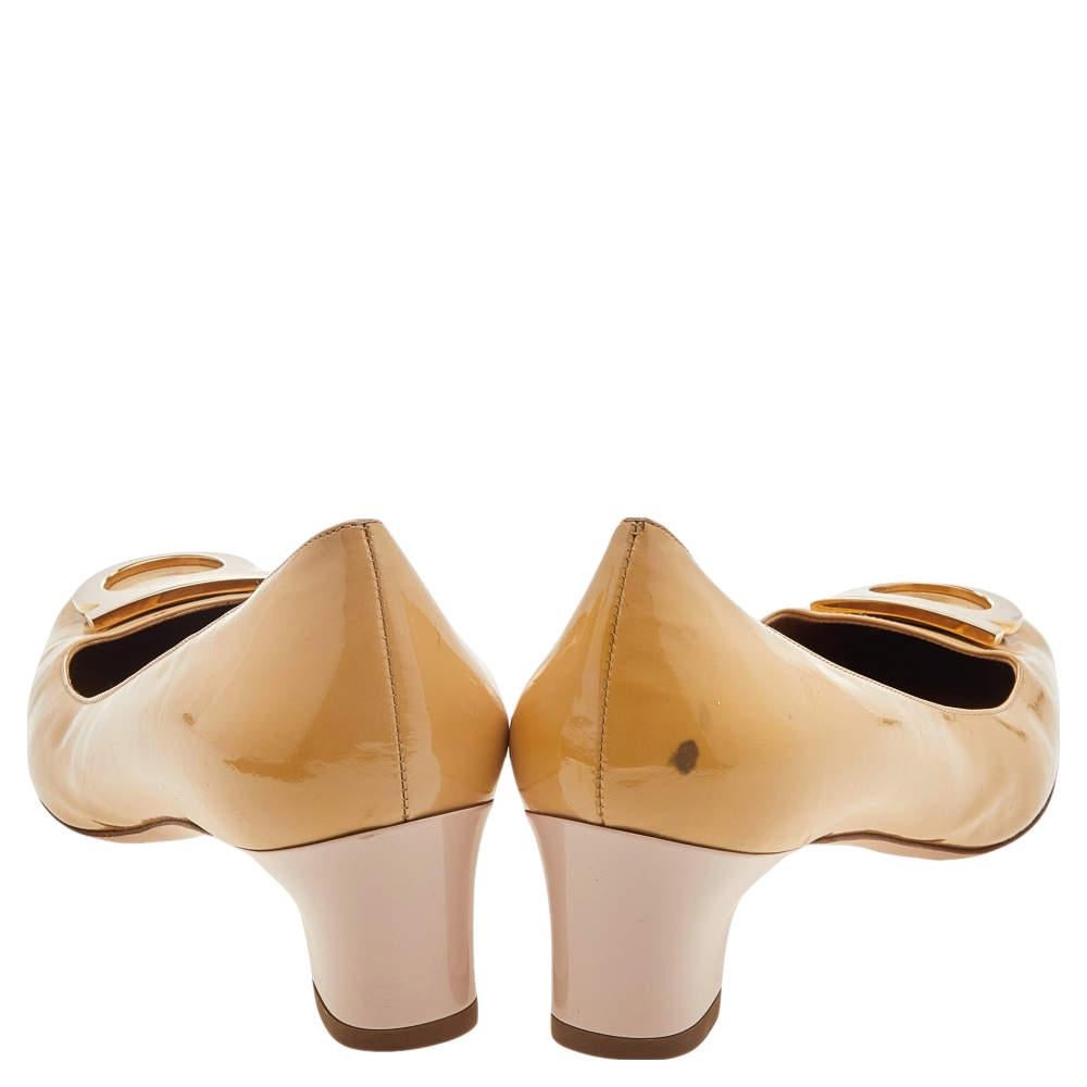 It is time to revamp your style quotient by adding this pair of Salvatore Ferragamo pumps to the ensemble. The dashing, neat look is possible in this pair of pumps. These pumps are leather and accented with the signature Gancini logo on the uppers