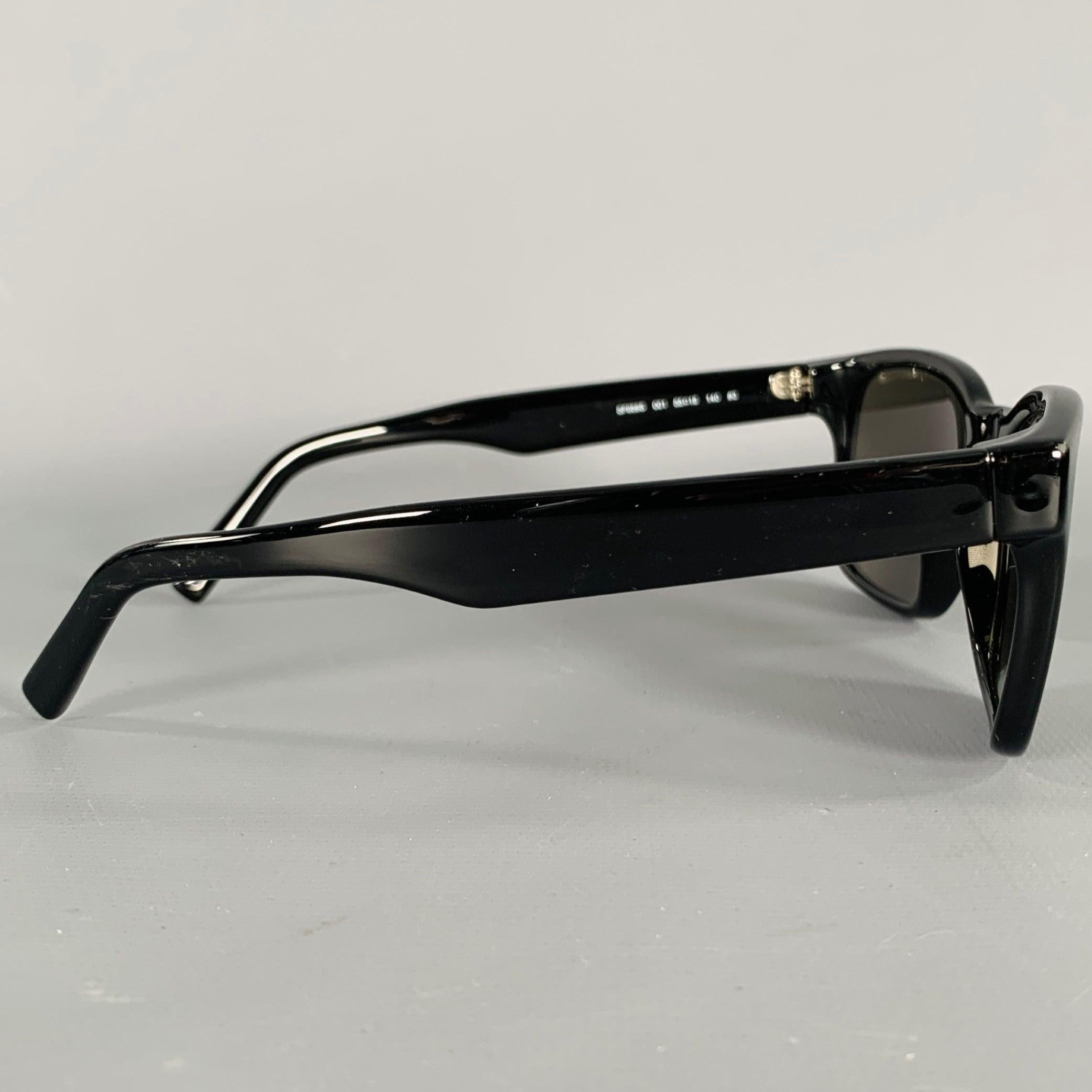 Lunettes de soleil SALVATORE FERRAGAMO
en acétate noir, avec une forme carrée et des verres teintés. Livré avec un étui en cuir saffiano. Fabriqué en Italie. Excellent état. 

Marqué :   SF959S 001 55 18 140 #3 

Mesures : 
  Largeur du cadre : 13,5