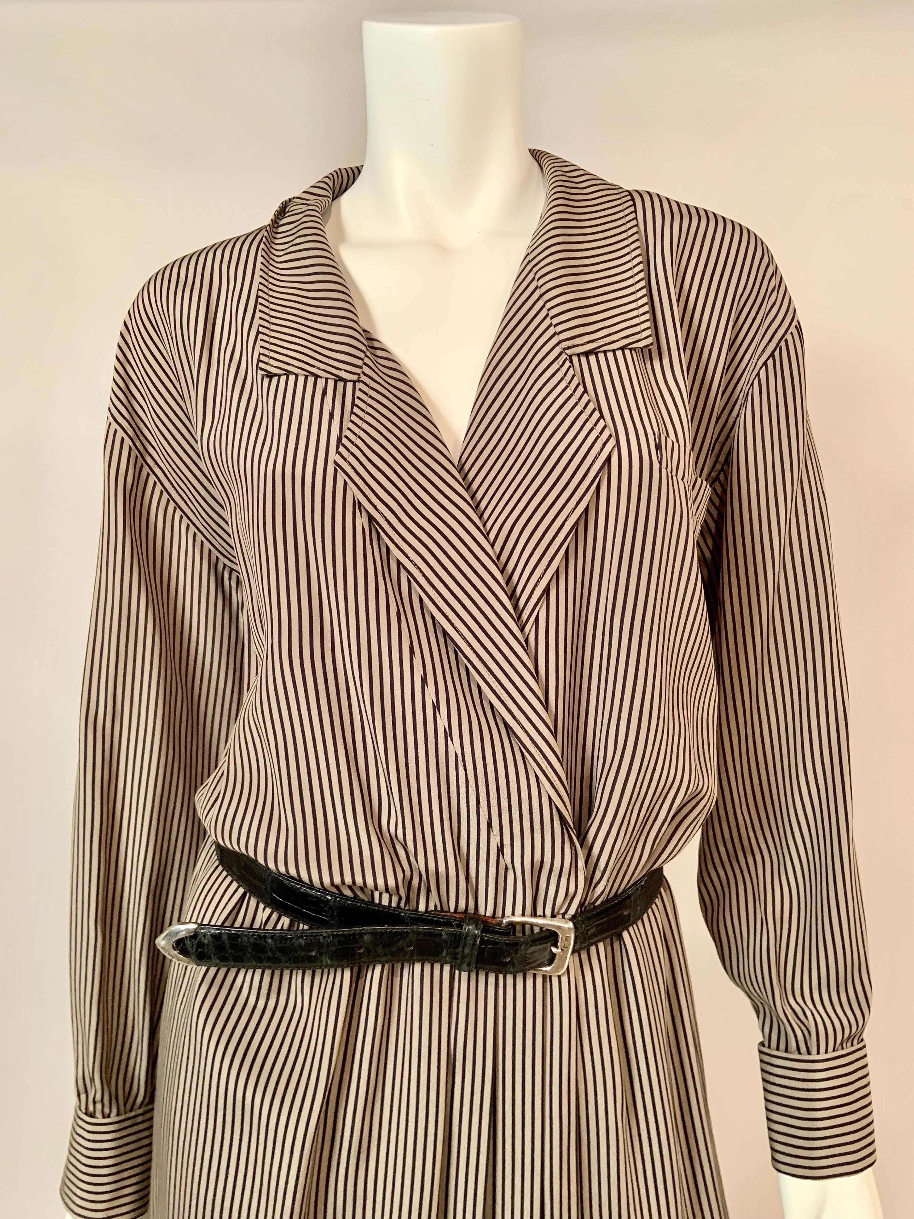 This striped silk dress from Salvatore Ferragamo is effortless dressing at the best level.
The dress has a peaked lapel, long sleeves with button cufflinks, an elasticized waist and a front opening with interior hooks at the waistline. The belt does