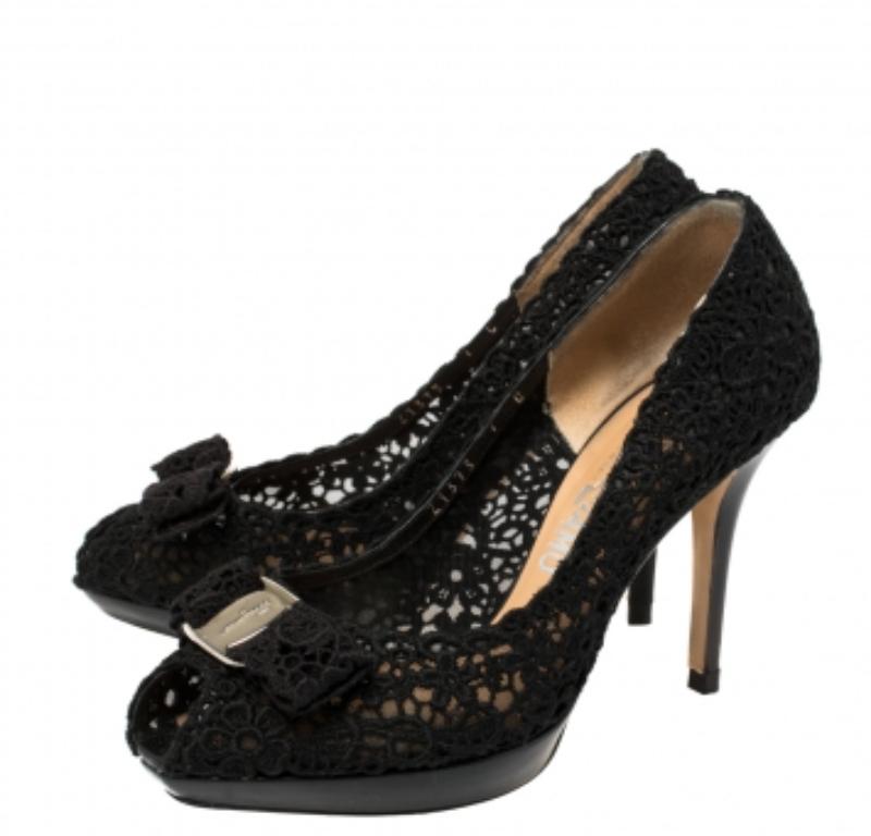 It is easy to fall in love with these pumps by Salvatore Ferragamo! They've been beautifully crafted using black lace and designed with bows, peep toes, platforms, and 9 cm heels. The pumps are sure to complement all your dresses and evening gowns.