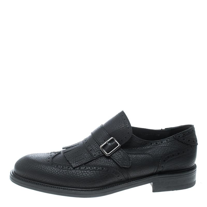 Take each step with style in these loafers from Salvatore Ferragamo. Crafted from leather, they carry a modern design of belts, wingtips, and fringes, in a timeless black hue with every stitch on them giving praise to quality and durability. The