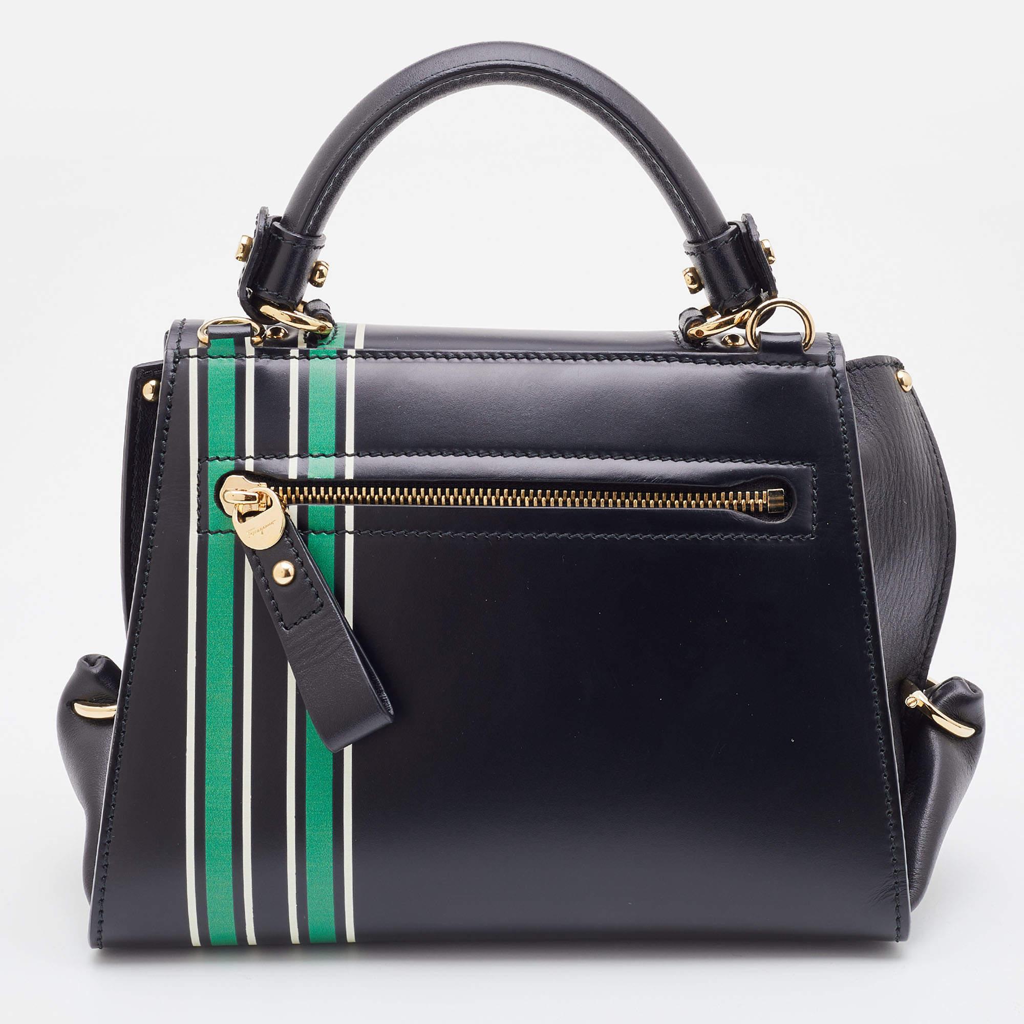 Carry this gorgeous Salvatore Ferragamo creation wherever you go and enjoy fashion with ease. Meticulously crafted from leather with an attractive floral print, this bag has been styled with a top handle, a shoulder strap, and a leather interior to