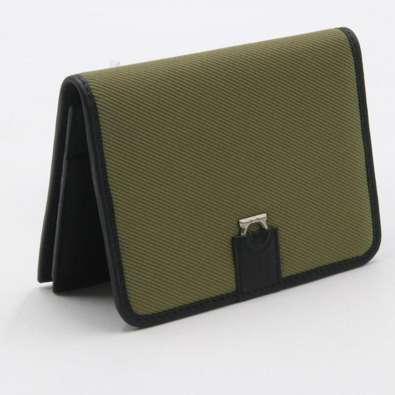 Salvatore Ferragamo Black Green Canvas & Leather Compact Flap Card Holder Wallet

This Salvatore Ferragamo Green Canvas Black Leather Card Holder Wallet is the most elegant way to organize your essentials like your bills, ID, and credit cards. It