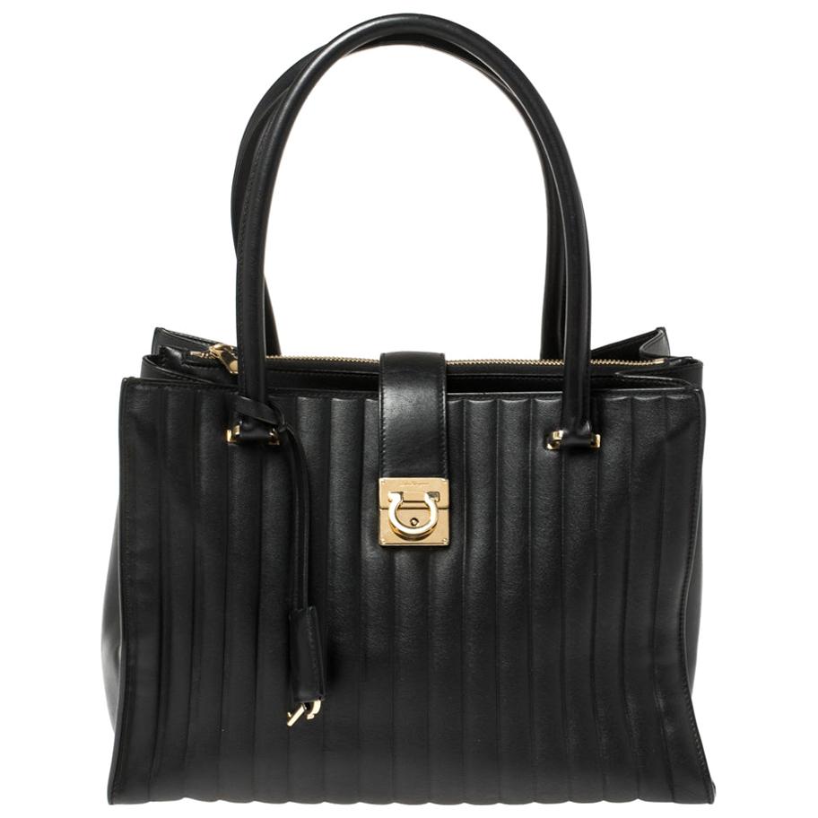 This Salvatore Ferragamo Batik tote has been crafted from black quilted leather. Made in Italy, the tote features a gold-tone logo at the center and dual top handles. The fabric-lined interior will hold your essentials dutifully. This elegant piece
