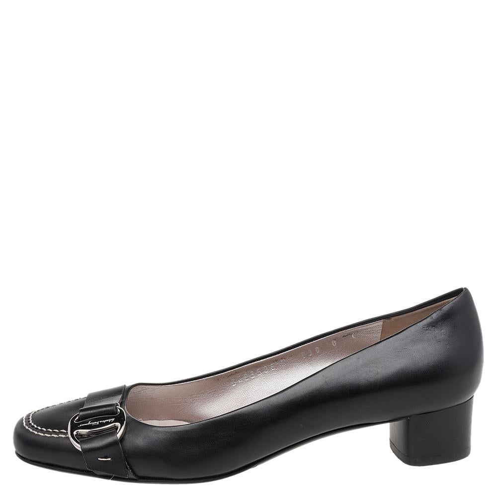 Endless compliments will come your way every time you wear these Salvatore Ferragamo pumps. The black pumps are crafted from leather and styled with almond toes, the signature Gancini detail on the uppers, and block heels. They are complete with