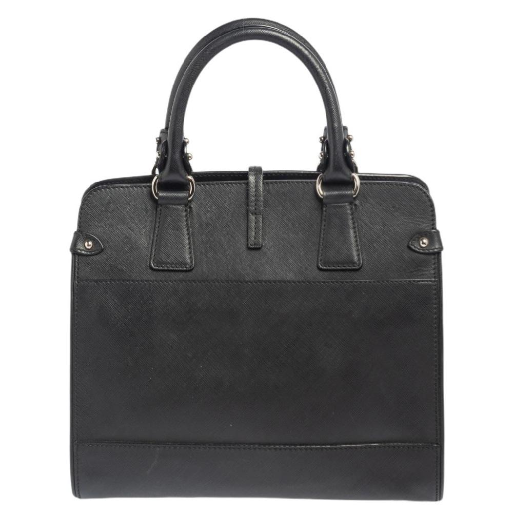 Crafted from leather, this Black Salvatore Ferragamo tote has a little lock-in flap and a spacious fabric interior. The bag is equipped with two handles and protective metal feet. Swing this beauty on your busy days as it is well-made and